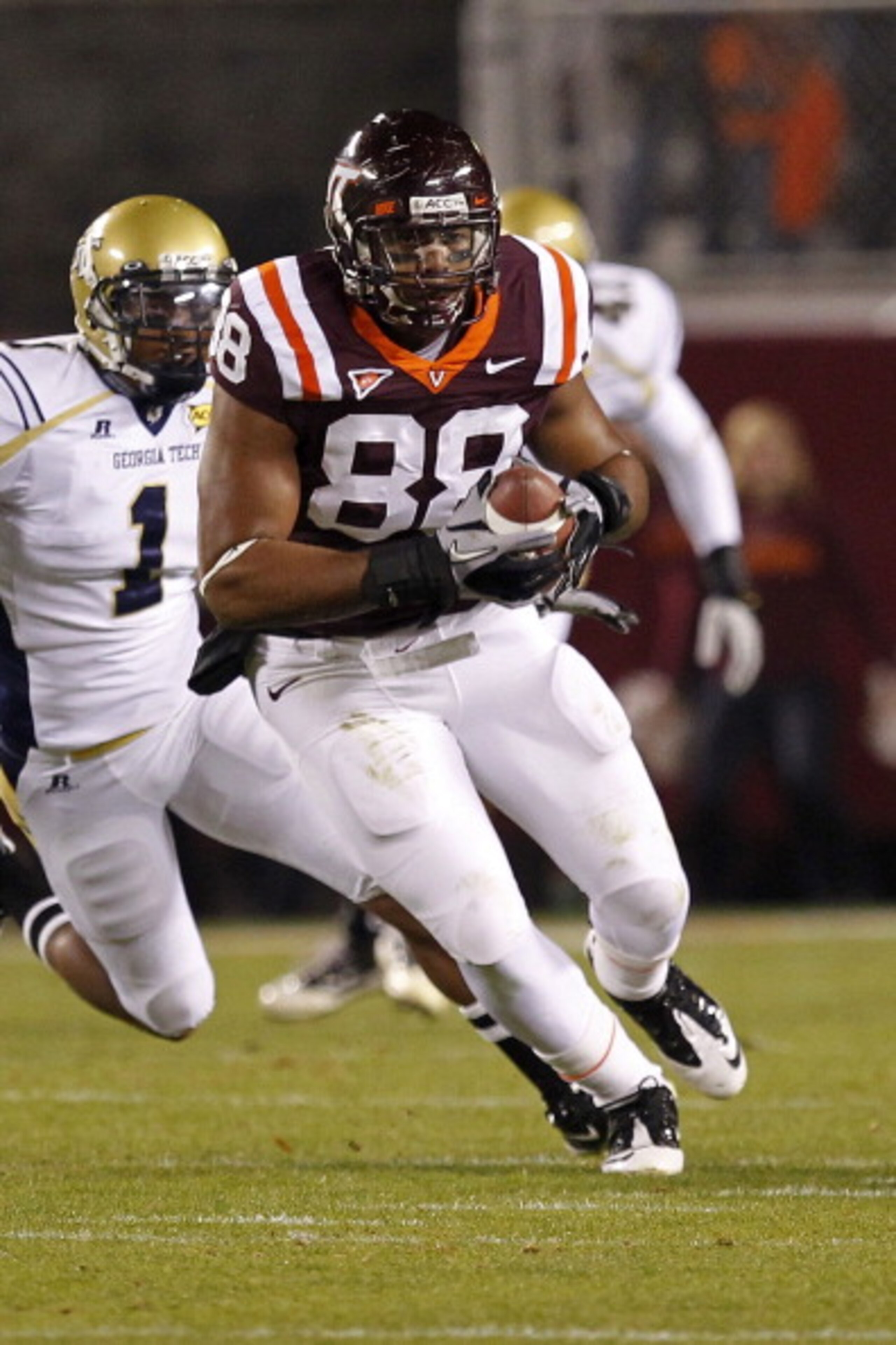 BLACKSBURG, VA - NOVEMBER 04: Tight end Andre Smith #88 of the Virginia Tech Hokies runs with the ball past safety Isaiah Johnson #1 of the Georgia Tech Yellow Jackets at Lane Stadium on November 4, 2010 in Blacksburg, Virginia.  (Photo by Geoff Burke/Get