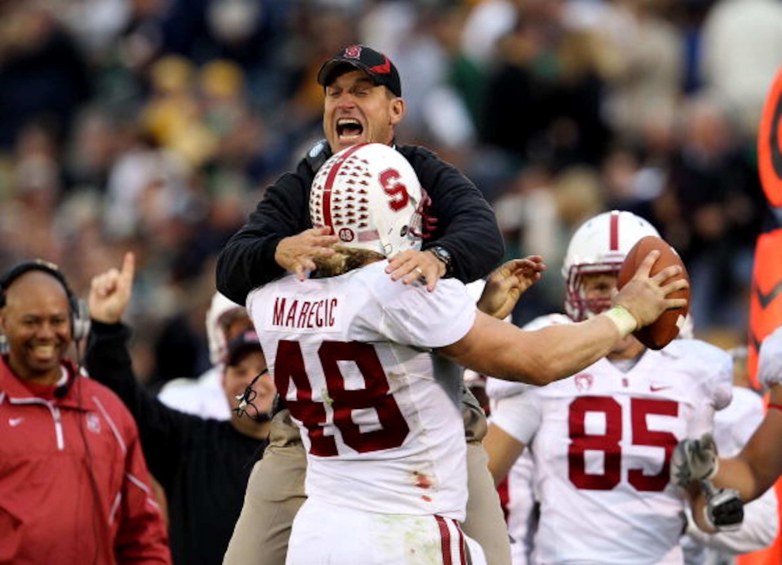 SOUTH BEND, IN - SEPTEMBER 25: Head coach Jim Harbaugh of the Stanford Cardinal jumps to greet Owen Marecic #48 after Marecic intercepted a pass for a touchdown against the Notre Dame Fighting Irish at Notre Dame Stadium on September 25, 2010 in South Ben