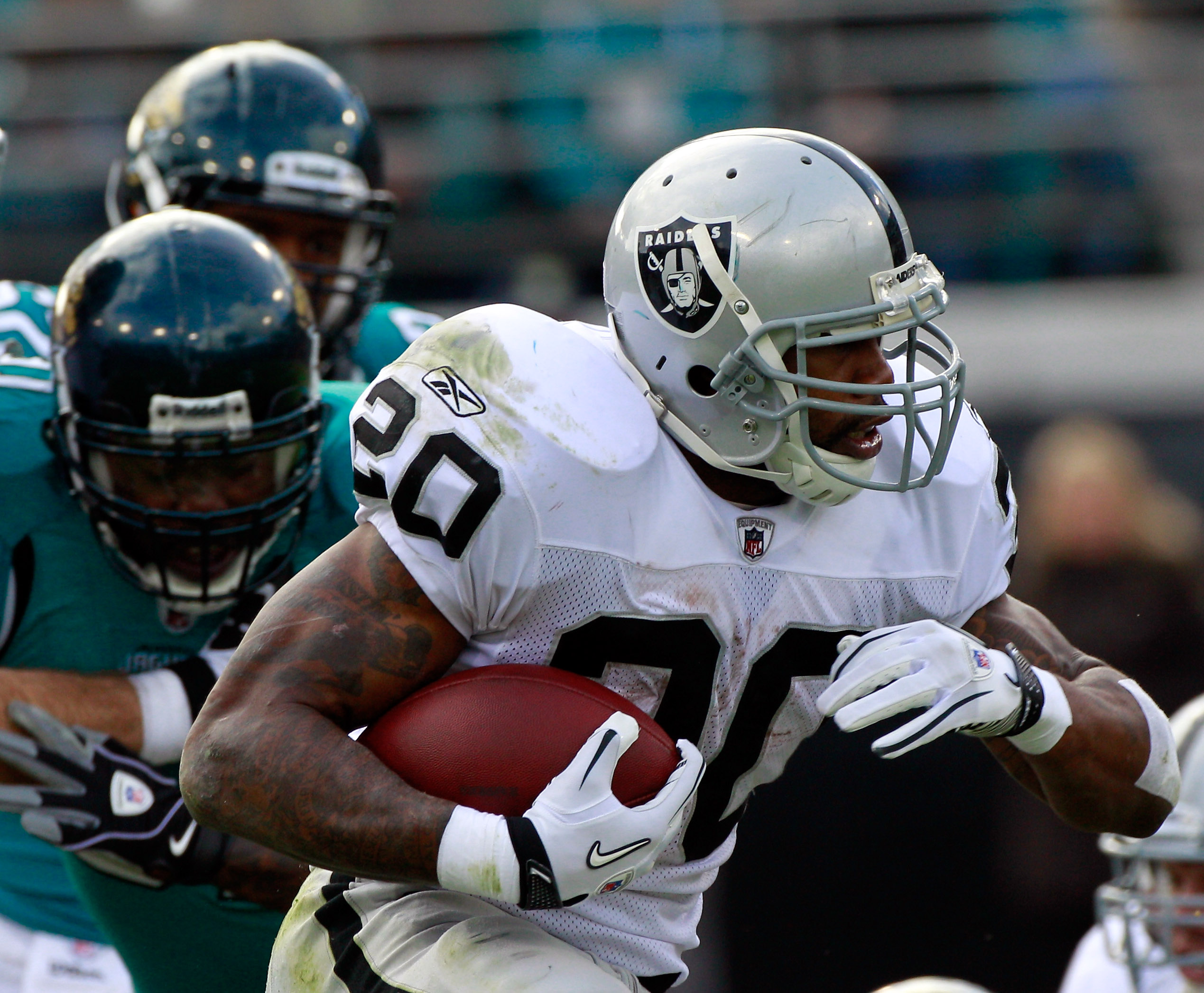 JACKSONVILLE, FL - DECEMBER 12:  Darren McFadden #20 of the Oakland Raiders runs for yardage during the game against the Jacksonville Jaguars at EverBank Field on December 12, 2010 in Jacksonville, Florida.  (Photo by Sam Greenwood/Getty Images)