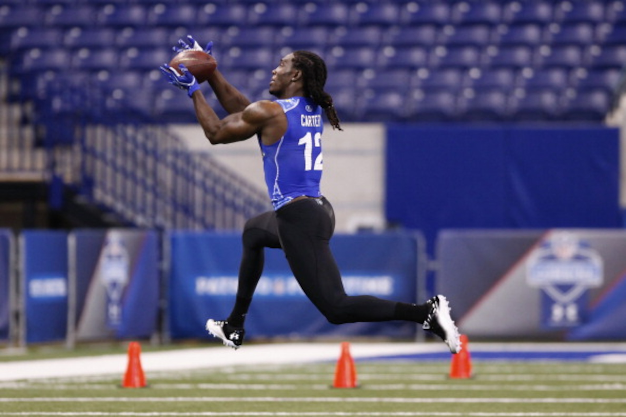 INDIANAPOLIS, IN - MARCH 1: Defensive back Quinton Carter #12 of Oklahoma works out during the 2011 NFL Scouting Combine at Lucas Oil Stadium on February 28, 2011 in Indianapolis, Indiana. (Photo by Joe Robbins/Getty Images)