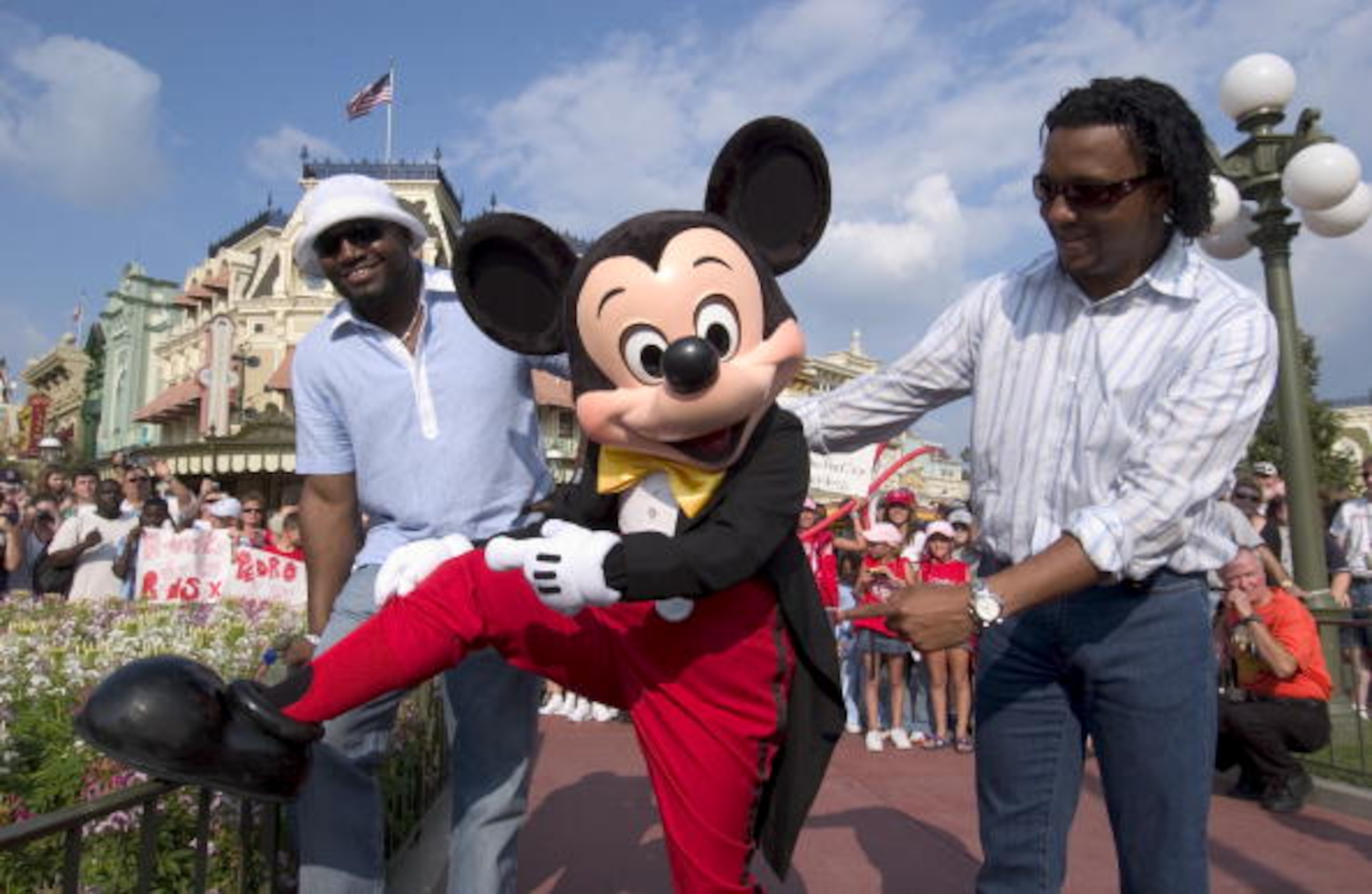 LAKE BUENA VISTA, FL - OCTOBER 29:  Boston Red Sox pitcher Pedro Martinez (R) and slugger David Ortiz (L) check out Mickey Mouse's red socks after a parade at Walt Disney World October 29, 2004 in Lake Buena Vista, Florida. Hundreds of fans turned out to