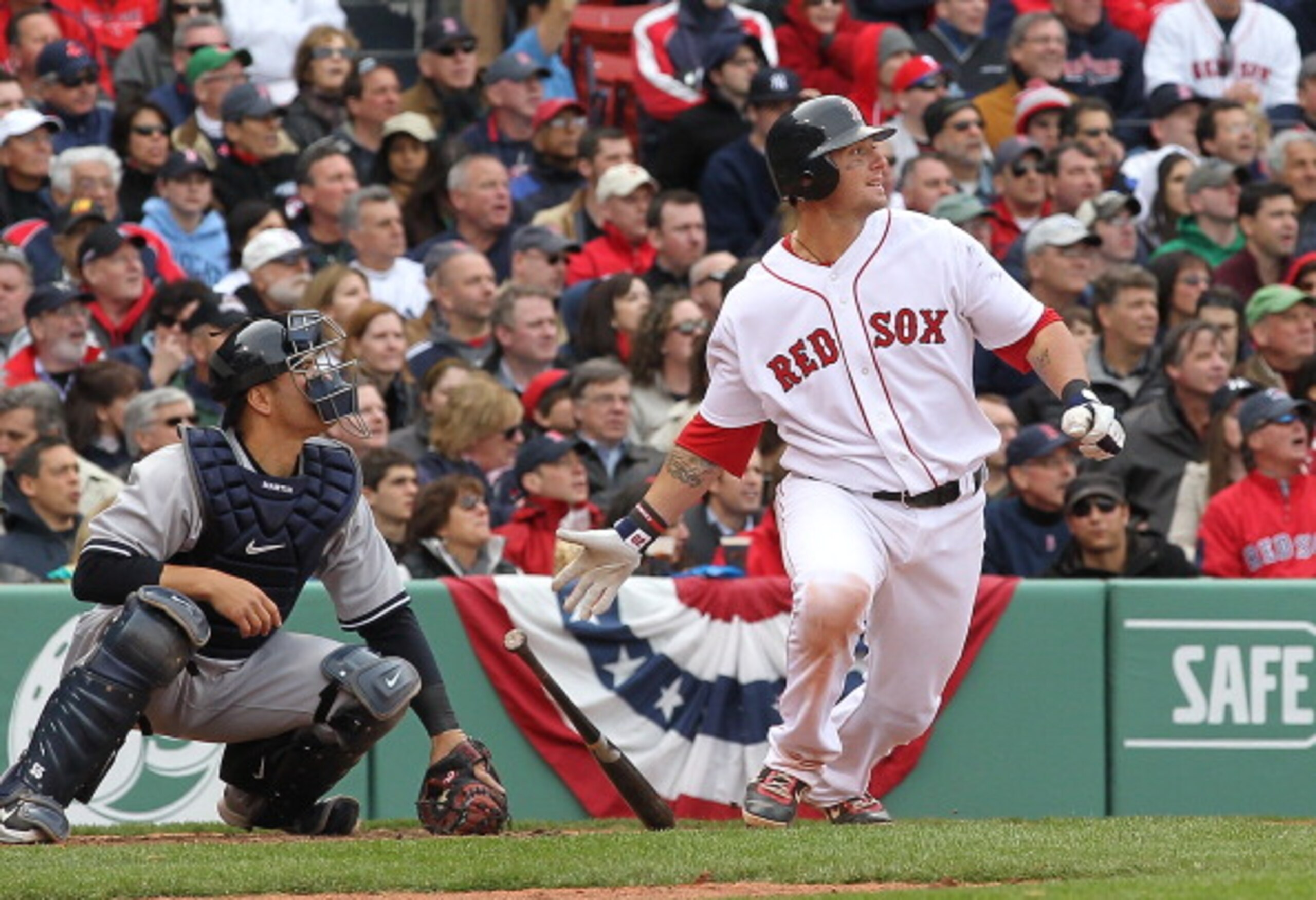 BOSTON, MA - APRIL 8:   Jarrod Saltalamacchia #39 of the Boston Red Sox knocks in the go-ahead run, scored by Kevin Youkilis #20, against the New York Yankees in the fifth inning on Opening Day at Fenway Park on April 8, 2011 in Boston, Massachusetts. (Ph