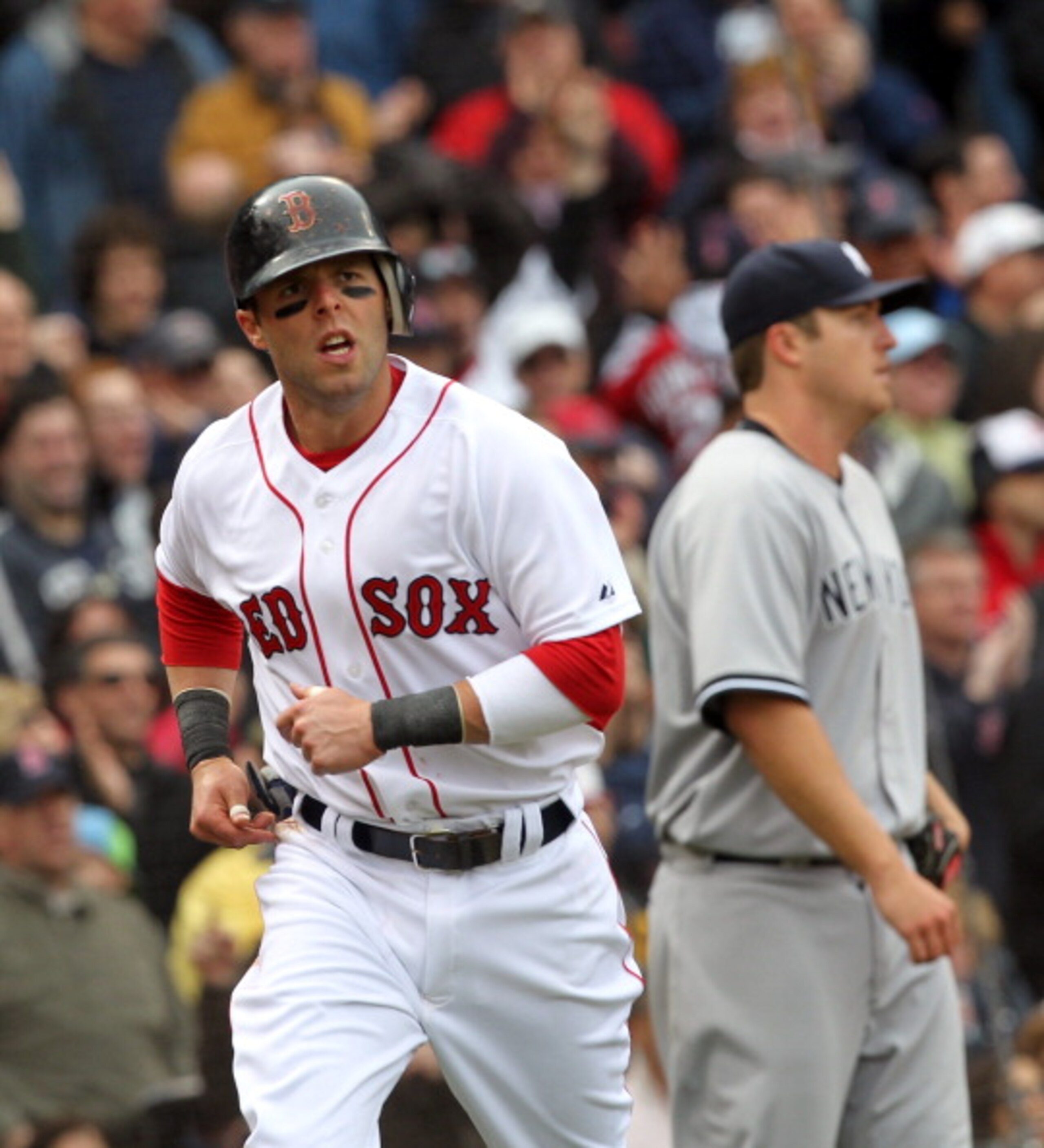 BOSTON, MA - APRIL 8:  Dustin Pedroia # 15 of the Boston Red Sox scores a run against Phil Hughes #65 of  the New York Yankees in the second  inning on Opening Day at Fenway Park on April 8, 2011 in Boston, Massachusetts. (Photo by Jim Rogash/Getty Images