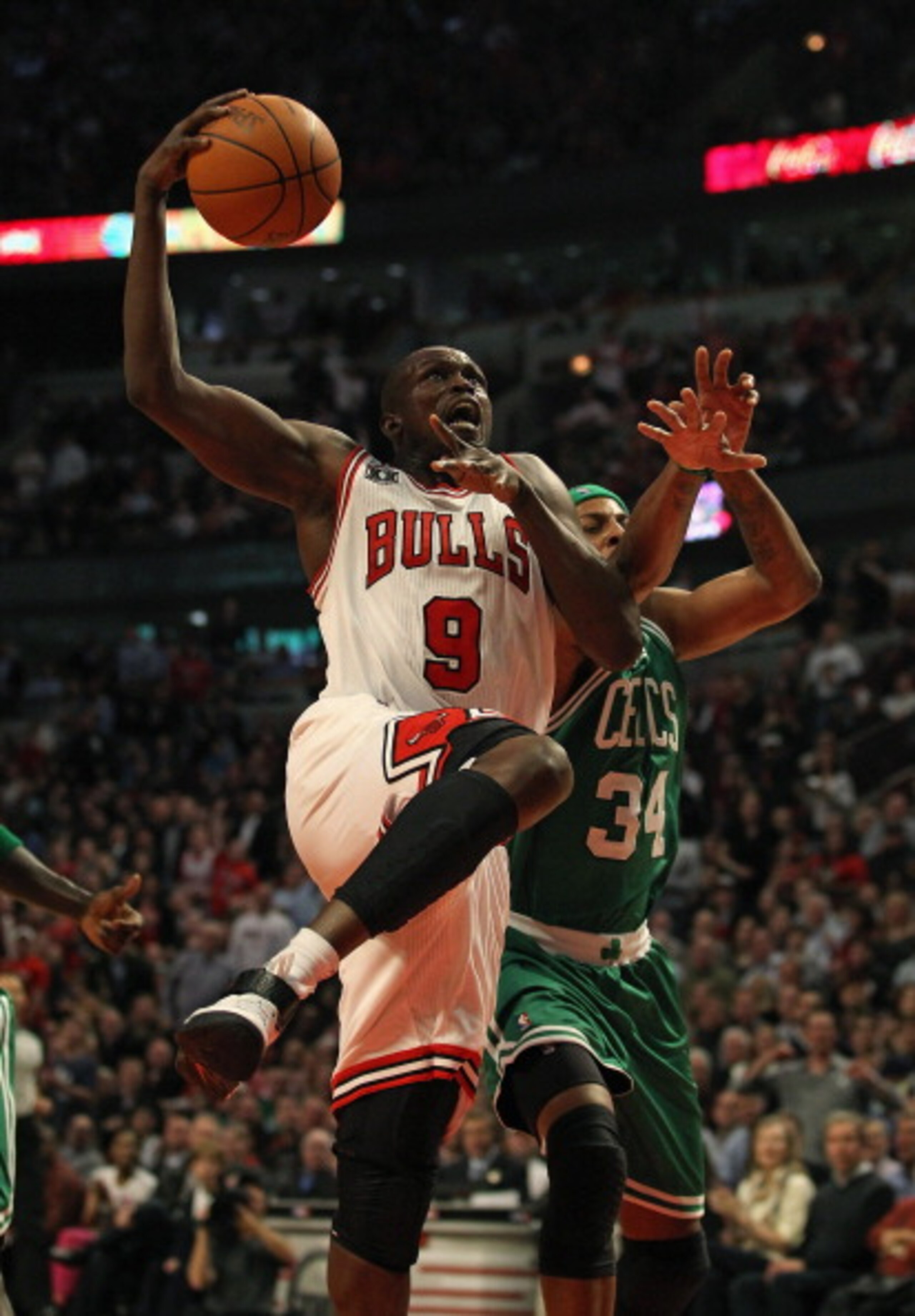 CHICAGO, IL - APRIL 07: Loul Deng #9 of the Chicago Bulls drives to the basket past Paul Pierce #34 of the Boston Celtics at United Center on April 7, 2011 in Chicago, Illinois. The Bulls defeated the Celtics 97-81. NOTE TO USER: User expressly acknowledg CHICAGO, IL - APRIL 07: Loul Deng #9 of the Chicago Bulls drives to the basket past Paul Pierce #34 of the Boston Celtics at United Center on April 7, 2011 in Chicago, Illinois. The Bulls defeated the Celtics 97-81. NOTE TO USER: User expressly acknowledg