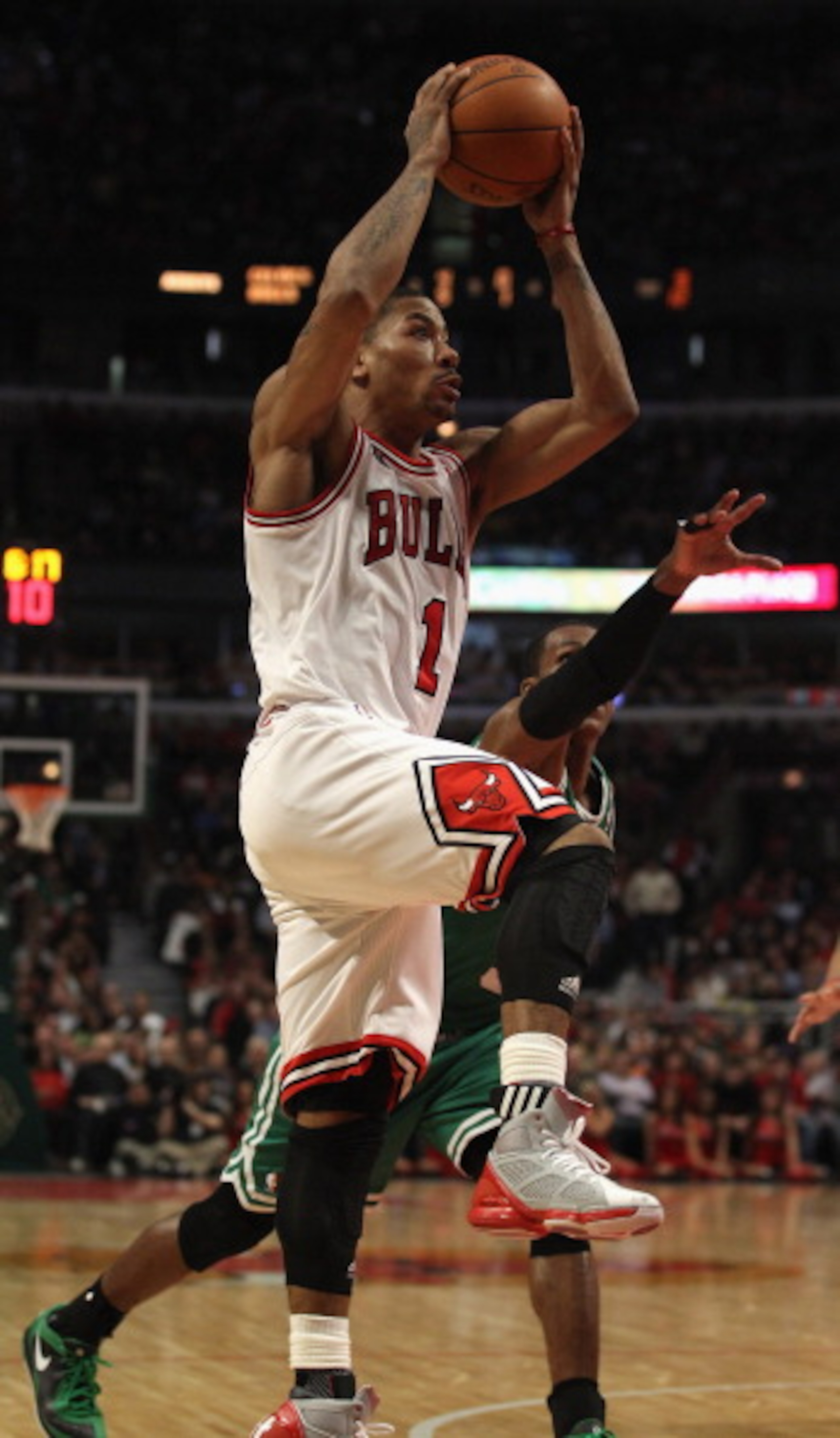 CHICAGO, IL - APRIL 07: Derrick Rose #1 of the Chicago Bulls goes up for a shot past Rajon Rondo #9 of the Boston Celtics at United Center on April 7, 2011 in Chicago, Illinois. The Bulls defeated the Celtics 97-81. NOTE TO USER: User expressly acknowledg CHICAGO, IL - APRIL 07: Derrick Rose #1 of the Chicago Bulls goes up for a shot past Rajon Rondo #9 of the Boston Celtics at United Center on April 7, 2011 in Chicago, Illinois. The Bulls defeated the Celtics 97-81. NOTE TO USER: User expressly acknowledg