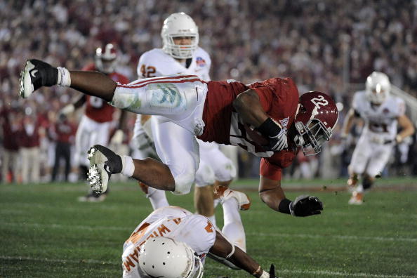 PASADENA, CA - JANUARY 07:  Running back Mark Ingram #22 of the Alabama Crimson Tide is tackled by cornerback Aaron Williams #4 of the Texas Longhorns during the Citi BCS National Championship game at the Rose Bowl on January 7, 2010 in Pasadena, Californ