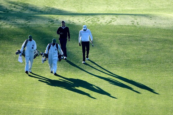 AUGUSTA, GA - APRIL 07:  Adam Scott of Australia and Nick Watney (R) walk with their caddies on the first hole during the first round of the 2011 Masters Tournament at Augusta National Golf Club on April 7, 2011 in Augusta, Georgia.  (Photo by Andrew Redi