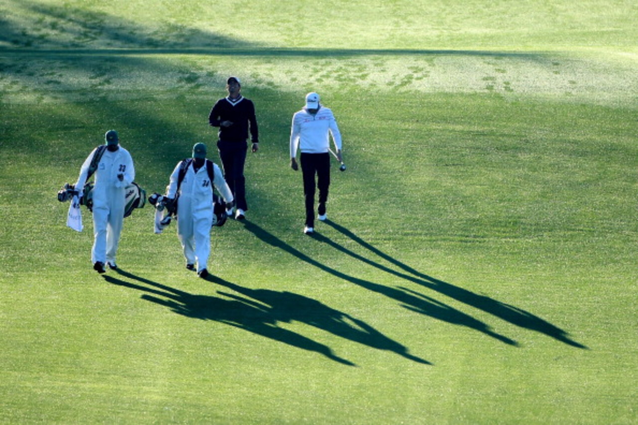 AUGUSTA, GA - APRIL 07:  Adam Scott of Australia and Nick Watney (R) walk with their caddies on the first hole during the first round of the 2011 Masters Tournament at Augusta National Golf Club on April 7, 2011 in Augusta, Georgia.  (Photo by Andrew Redi