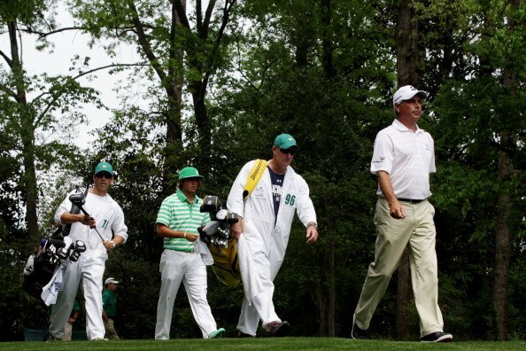 AUGUSTA, GA - APRIL 09:  Fred Couples (R) and Rickie Fowler walk off the second tee with their caddies during the third round of the 2011 Masters Tournament at Augusta National Golf Club on April 9, 2011 in Augusta, Georgia.  (Photo by David Cannon/Getty