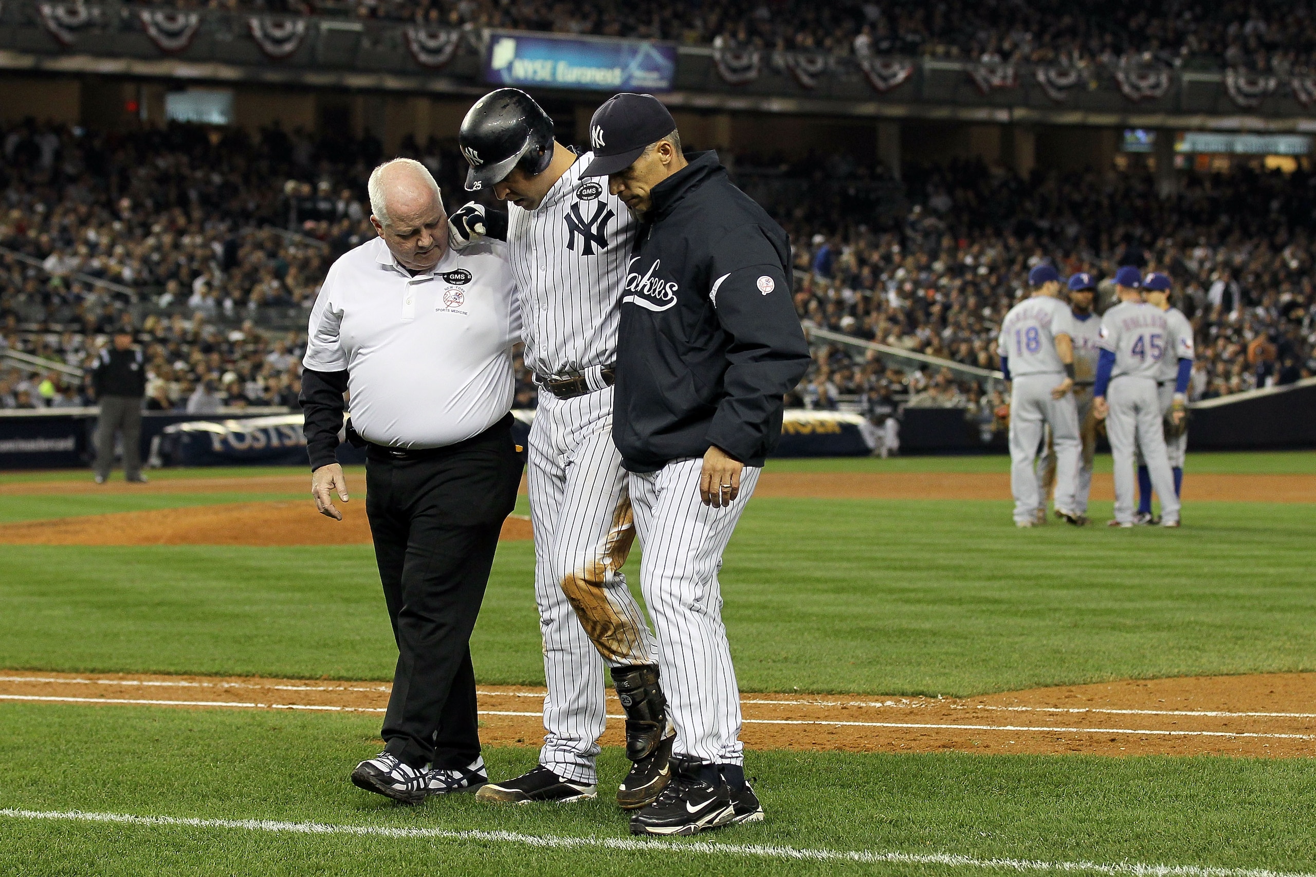 NEW YORK - OCTOBER 19: Mark Teixeira #25 of the New York Yankees is helped off of the field by Manager Joe Girardi and a trainer after hurting himself while playing against the Texas Rangers in Game Four of the ALCS during the 2010 MLB Playoffs at Yankee NEW YORK - OCTOBER 19: Mark Teixeira #25 of the New York Yankees is helped off of the field by Manager Joe Girardi and a trainer after hurting himself while playing against the Texas Rangers in Game Four of the ALCS during the 2010 MLB Playoffs at Yankee