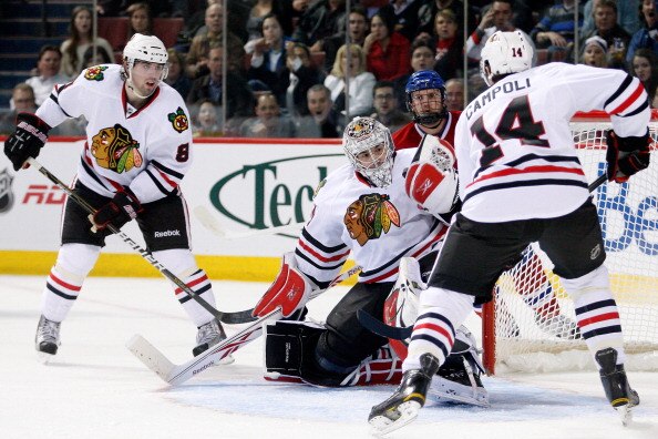 MONTREAL, CANADA - APRIL 5:  Corey Crawford #50 of the Chicago Blackhawks makes a glove save on the puck on an attempt by James Wisniewski (not shown) of the Montreal Canadiens during the NHL game at the Bell Centre on April 5, 2011 in Montreal, Quebec, C