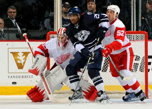 NASHVILLE, TN - APRIL 02:  Joel Ward #29 of the Nashville Predators fights through the defense of Jonathan Ericsson #52 of the Detroit Red Wings in front of Red Wings goalie Jimmy Howard  #35 on April 2, 2011 at the Bridgestone Arena in Nashville, Tenness
