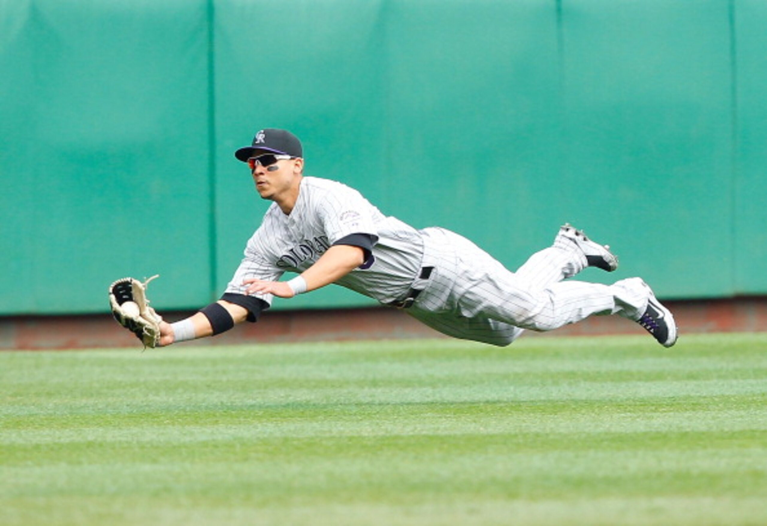 PITTSBURGH - APRIL 07: Carlos Gonzalez #5 of the Colorado Rockies makes a diving catch during the Opening Day game against the Pittsburgh Pirates on April 7, 2011 at PNC Park in Pittsburgh, Pennsylvania. (Photo by Jared Wickerham/Getty Images) PITTSBURGH - APRIL 07: Carlos Gonzalez #5 of the Colorado Rockies makes a diving catch during the Opening Day game against the Pittsburgh Pirates on April 7, 2011 at PNC Park in Pittsburgh, Pennsylvania. (Photo by Jared Wickerham/Getty Images)