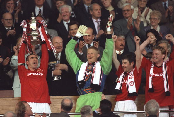 11 May 1996:  Eric Cantona (left) of Manchester United holds aloft the trophy and Peter Schmeical (second left) Denis Irwin (second right) and David May (right) all of Manchester United celebrate after winning the F A Cup Final match against Liverpool atW