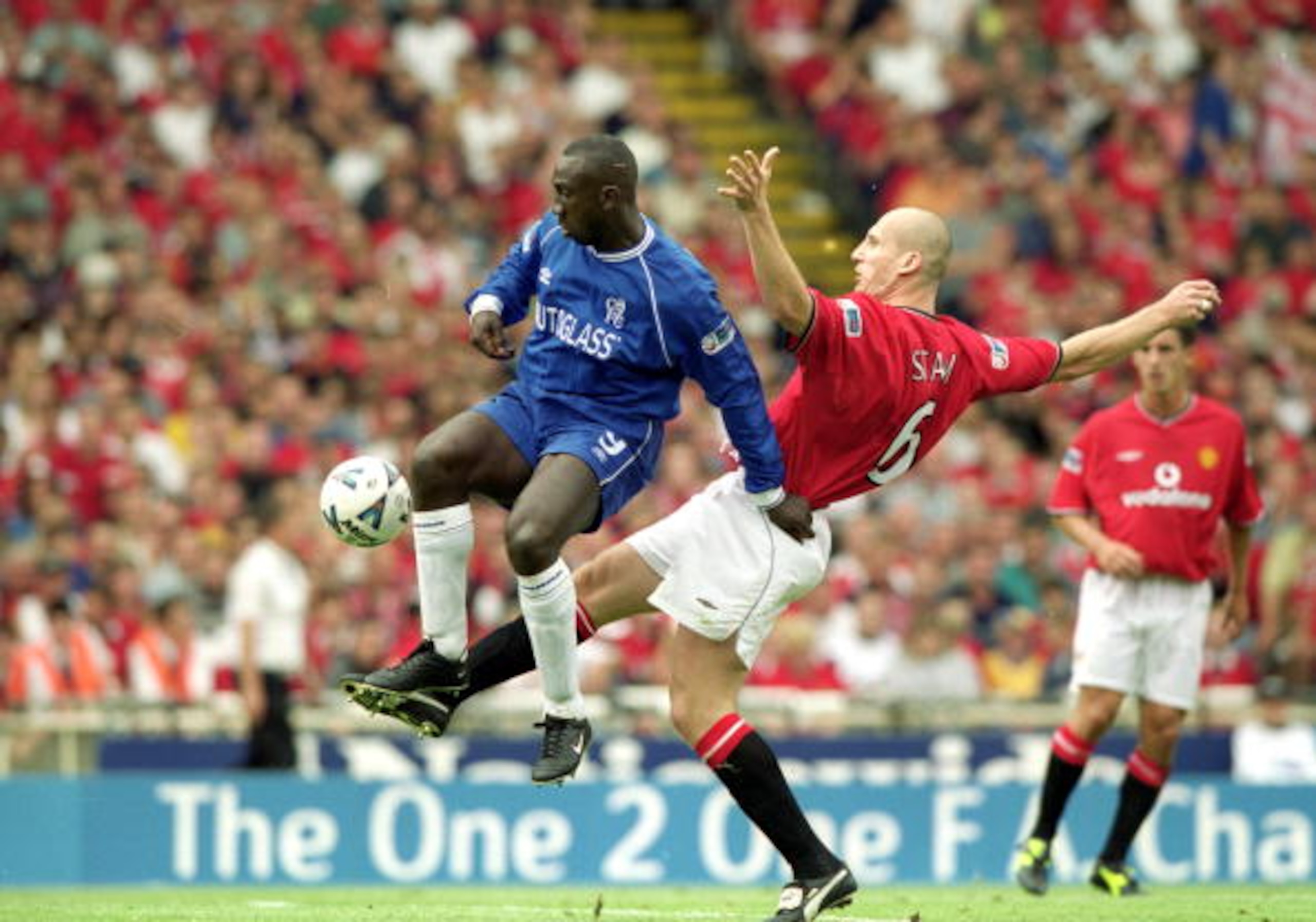 13 Aug 2000:  Jimmy Hasselbaink (blue shirt) of Chelsea beats Jaap Stam (red shirt) of Manchester United during the One 2 One FA Charity Shield match at Wembley Stadium, London. Chelsea won the match 2-0. \ Mandatory Credit: Graham Chadwick /Allsport