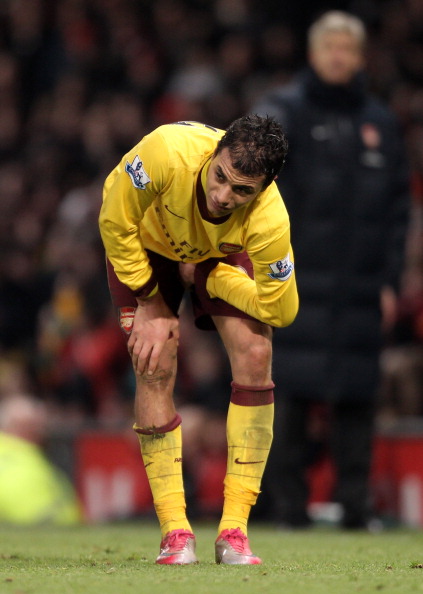 MANCHESTER, UNITED KINGDOM - DECEMBER 13:   Marouane Chamakh of Arsenal holds his leg after sustaining an injury during the Barclays Premier League match between Manchester United and Arsenal at Old Trafford on December 13, 2010 in Manchester, England. (P