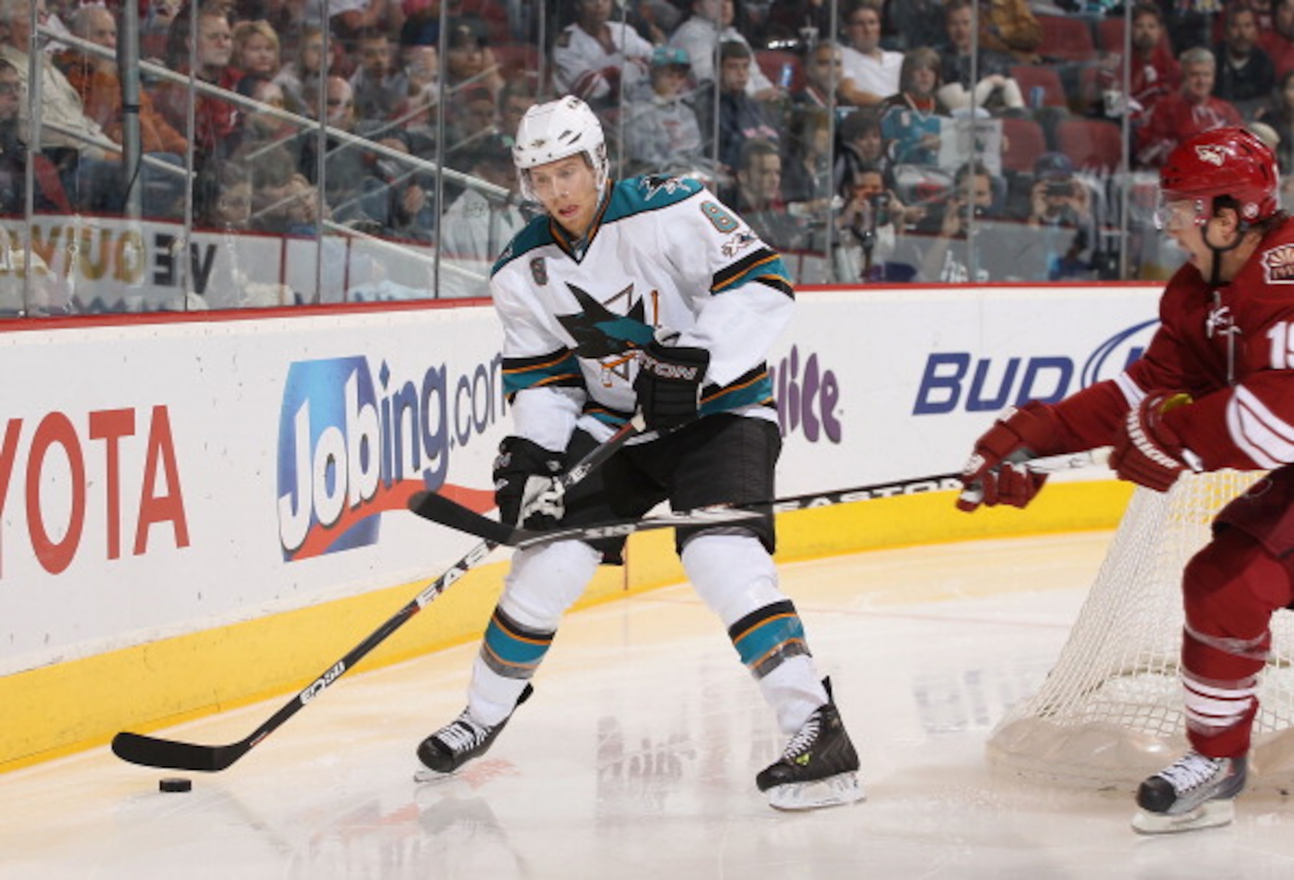GLENDALE, AZ - MARCH 26:  Joe Pavelski #8 of the San Jose Sharks skates with the puck during the NHL game against the Phoenix Coyotes at Jobing.com Arena on March 26, 2011 in Glendale, Arizona. The Sharks defeated the Coyotes 4-1.  (Photo by Christian Pet