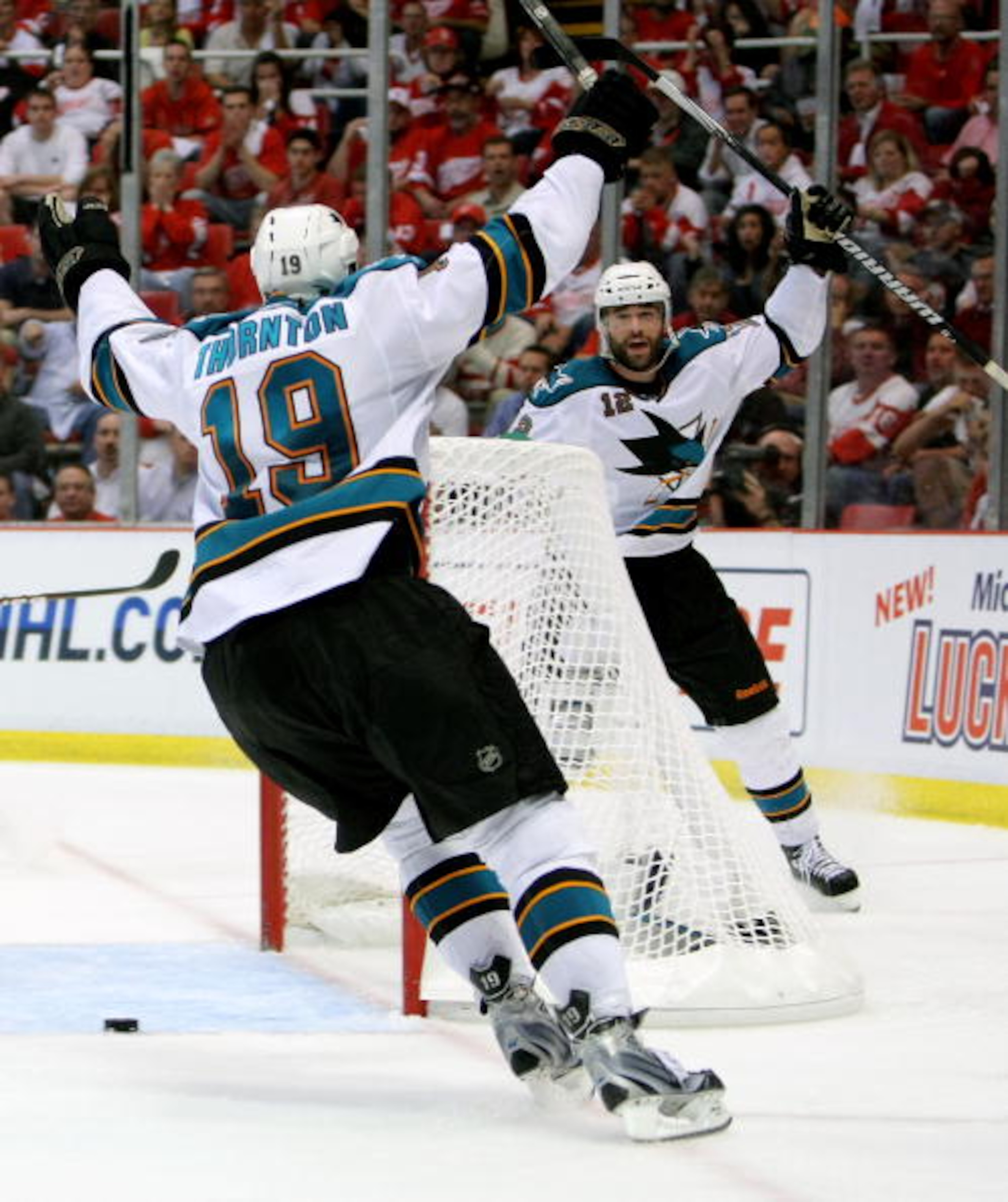 DETROIT - MAY 4:  Patrick Marleau #12 of the San Jose Sharks celebrates his overtime game-winning goal with teammate Joe Thornton #19 who assisted on the goal against the Detroit Red Wings in Game Three of the Western Conference Semifinals during the 2010