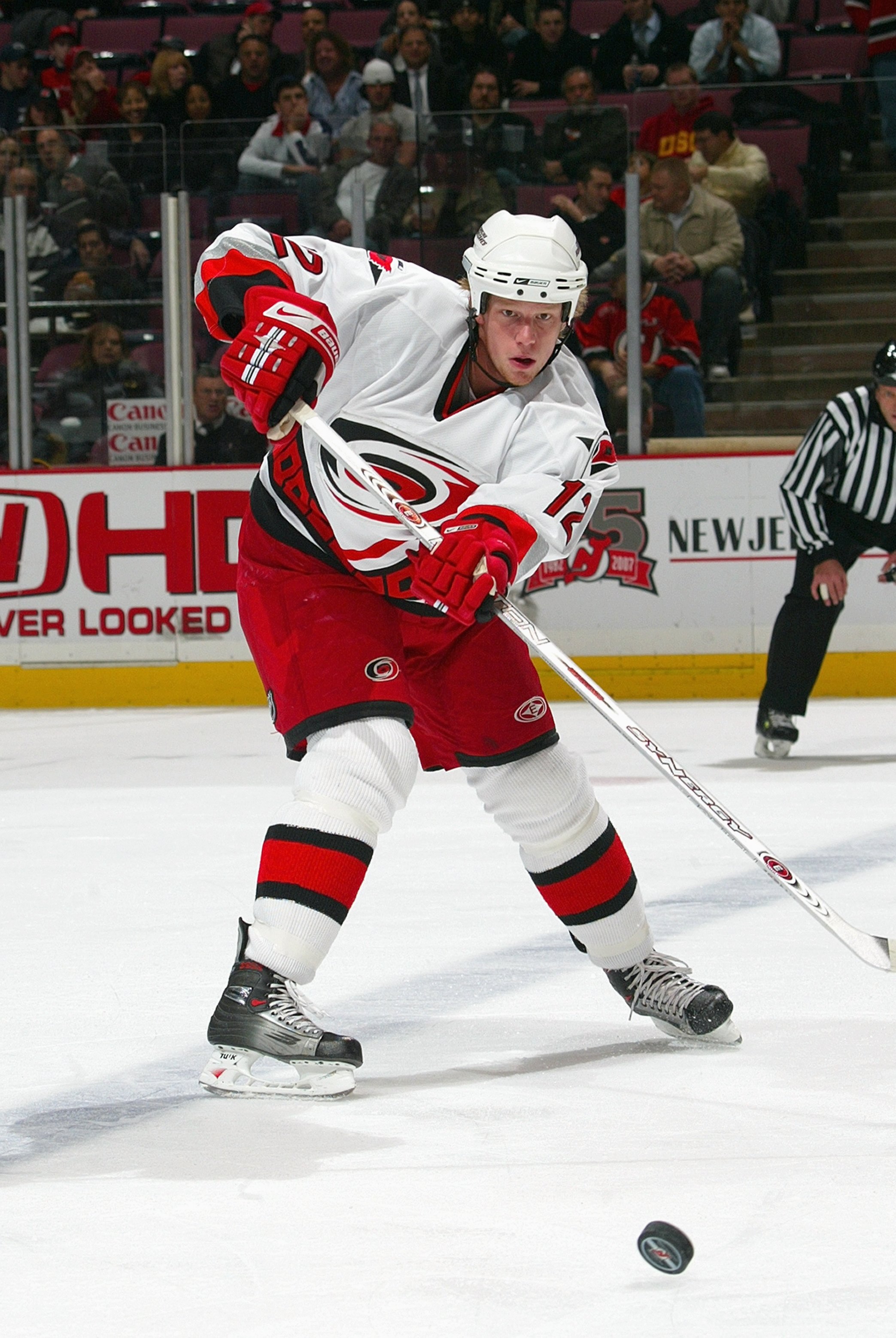 EAST RUTHERFORD, NJ - NOVEMBER 7: Eric Staal #12of the Carolina Hurricanes passes the puck during the game against the New Jersey Devils on November 7, 2006 at the Continental Airlines Arena in East Rutherford, New Jersey. (Photo by Bruce Bennett/Getty Im
