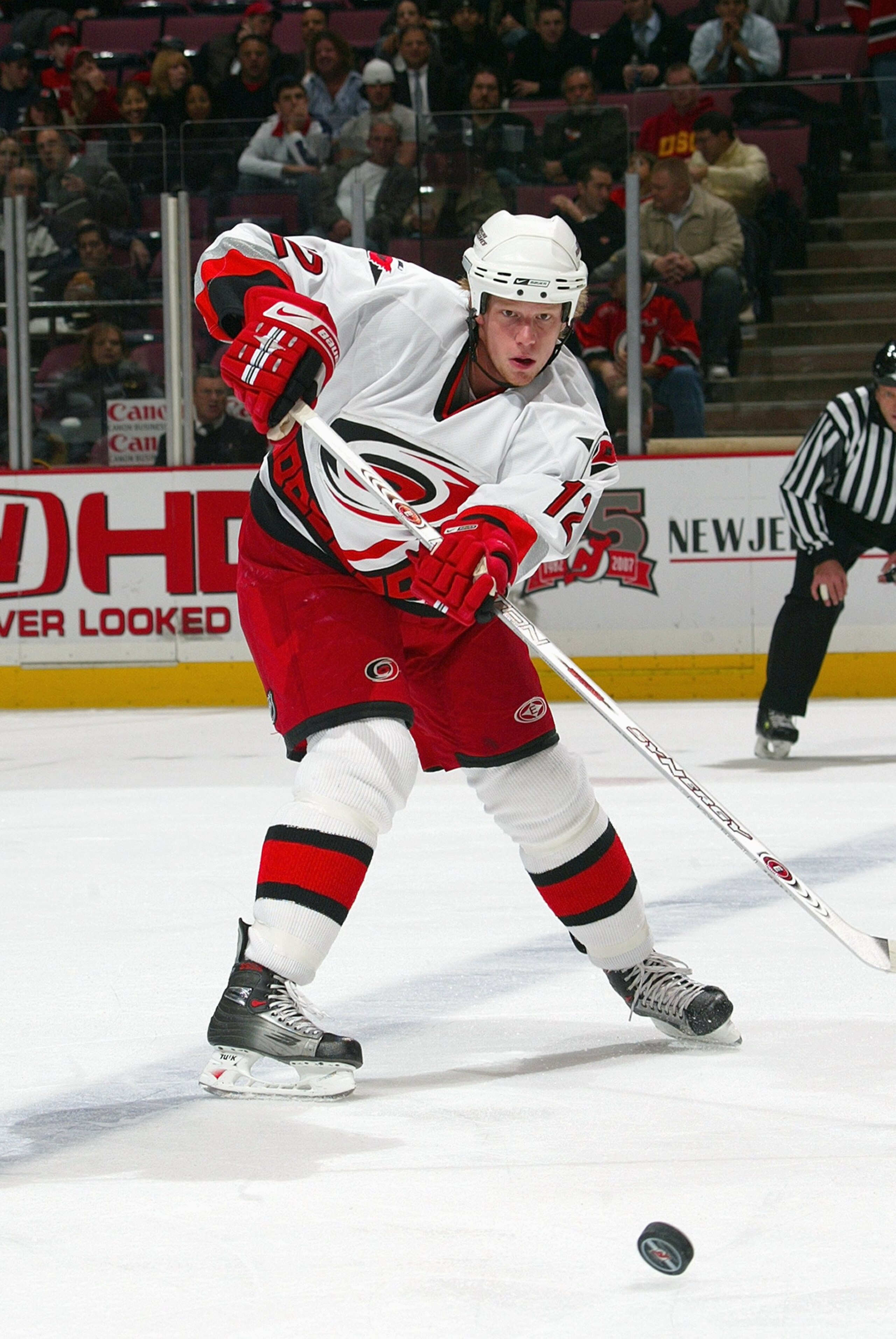 EAST RUTHERFORD, NJ - NOVEMBER 7: Eric Staal #12of the Carolina Hurricanes passes the puck during the game against the New Jersey Devils on November 7, 2006 at the Continental Airlines Arena in East Rutherford, New Jersey. (Photo by Bruce Bennett/Getty Im