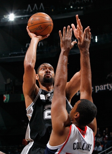 ATLANTA, GA - APRIL 05: Tim Duncan #21 of the San Antonio Spurs shoots against Jason Collins #34 of the Atlanta Hawks at Philips Arena on April 5, 2011 in Atlanta, Georgia. NOTE TO USER: User expressly acknowledges and agrees that, by downloading and/or