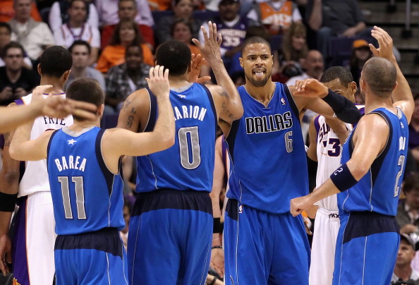 PHOENIX, AZ - MARCH 27:  Tyson Chandler #6 of the Dallas Mavericks high fives teammates Jose Barea #11, Shawn Marion #0 and Jason Kidd #2 after scoring against the Phoenix Suns during the NBA game at US Airways Center on March 27, 2011 in Phoenix, Arizona