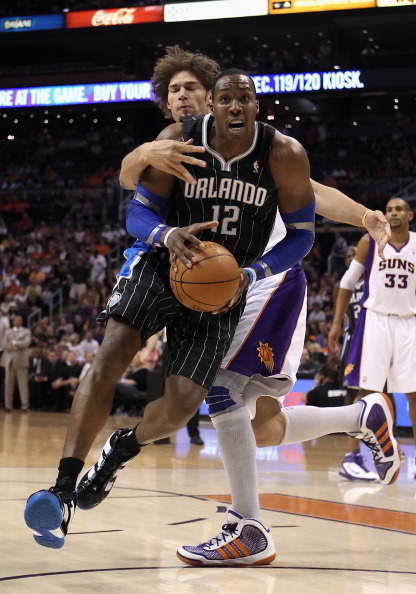 PHOENIX, AZ - MARCH 13:  Dwight Howard #12 of the Orlando Magic drives to the basket during the NBA game against the Phoenix Suns at US Airways Center on March 13, 2011 in Phoenix, Arizona. The Magic defeated the Suns 111-88. NOTE TO USER: User expressly