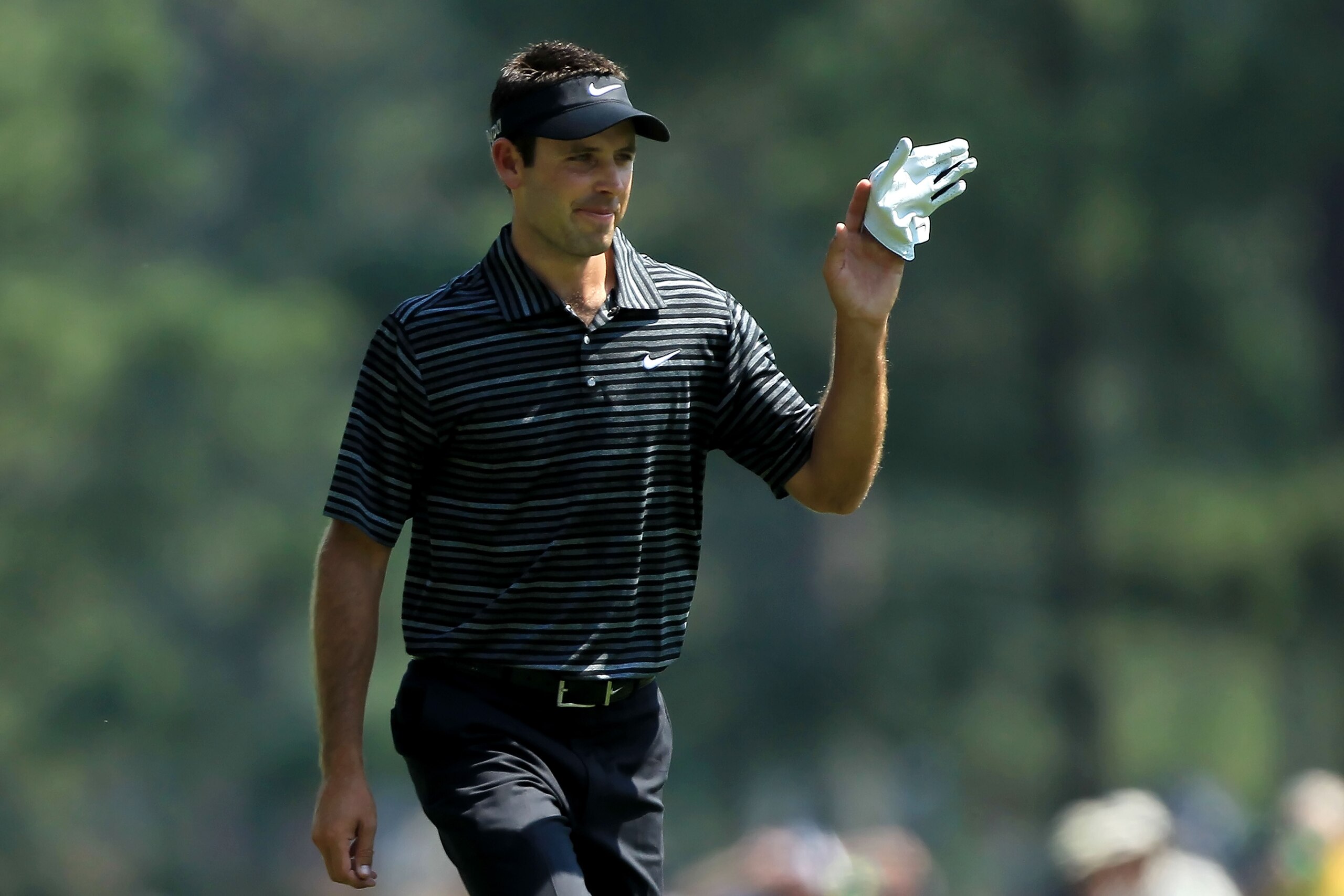 AUGUSTA, GA - APRIL 10:  Charl Schwartzel of South Africa waves to the gallery after holing a shot for eagle on the third green during the final round of the 2011 Masters Tournament on April 10, 2011 in Augusta, Georgia.  (Photo by David Cannon/Getty Imag
