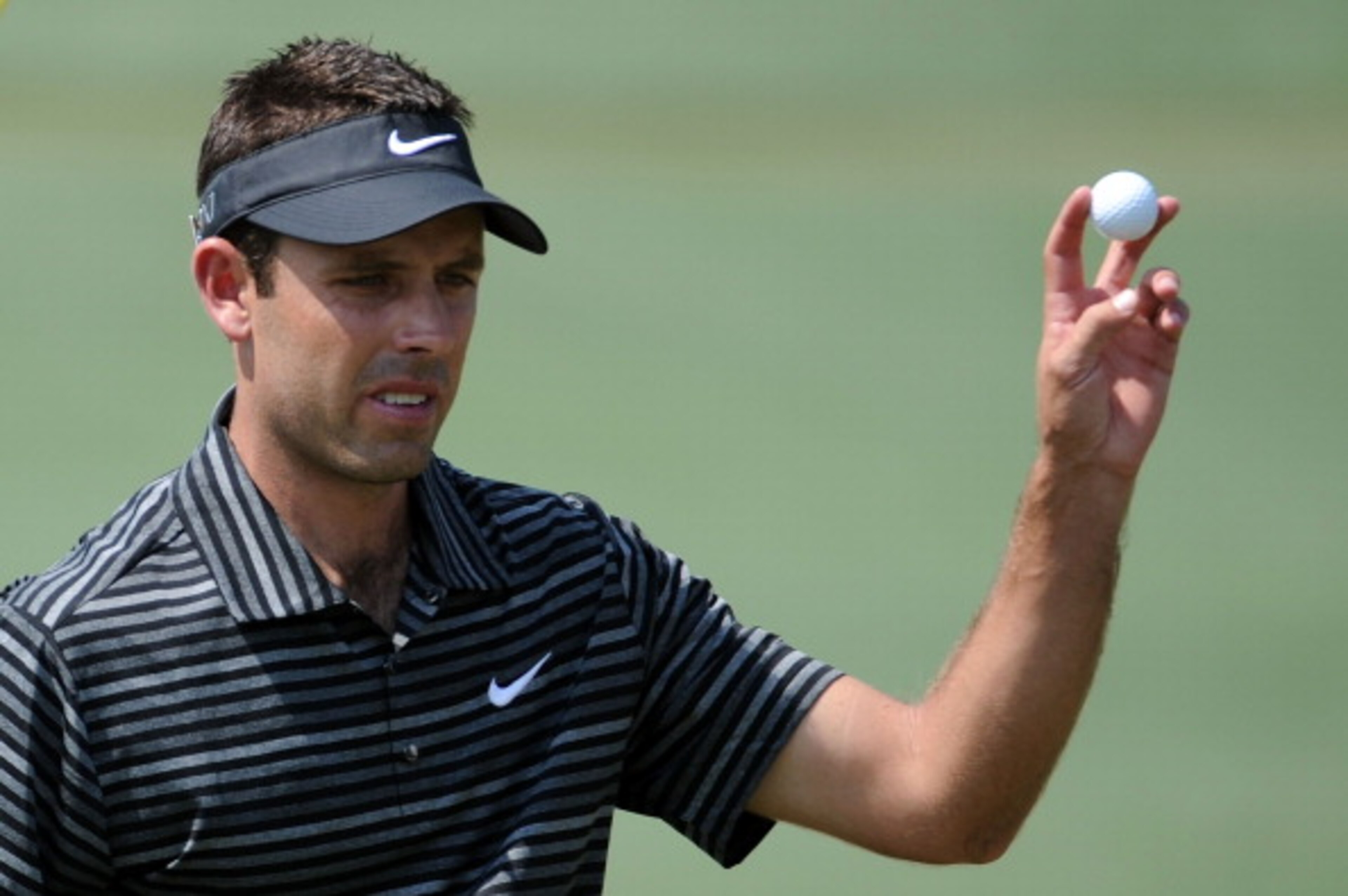 AUGUSTA, GA - APRIL 10:  Charl Schwartzel of South Africa waves to the gallery on the second green during the final round of the 2011 Masters Tournament on April 10, 2011 in Augusta, Georgia.  (Photo by Harry How/Getty Images)