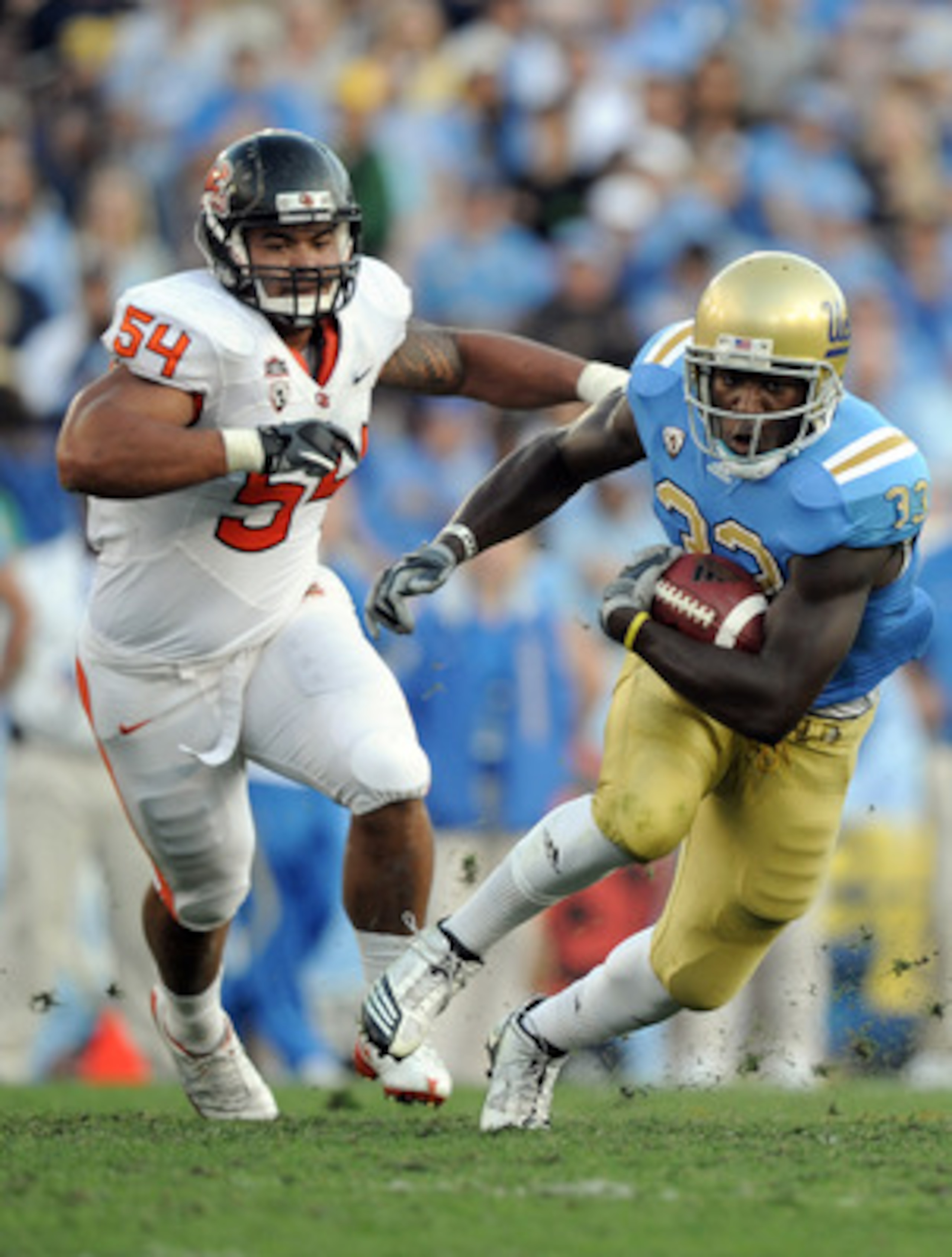 PASADENA, CA - NOVEMBER 06:  Derrick Coleman #33 of the UCLA Bruins runs away from Stephen Paea #54 of the Oregon State Beavers during the second quarter at the Rose Bowl on November 6, 2010 in Pasadena, California.  (Photo by Harry How/Getty Images)