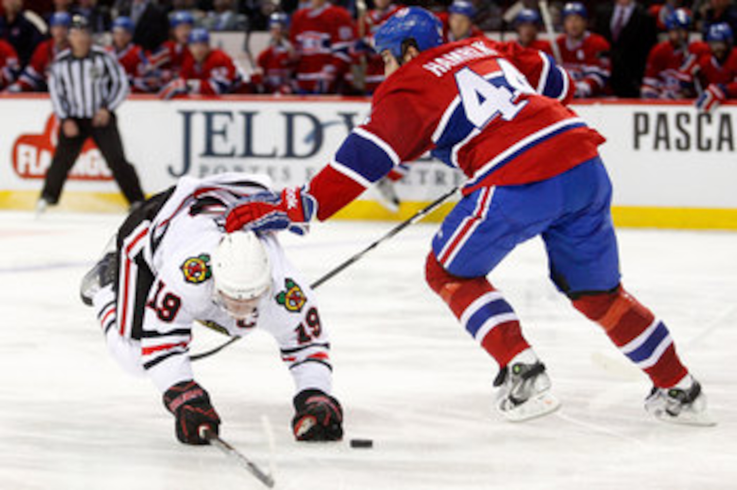 MONTREAL, CANADA - APRIL 5:  Roman Hamrlik #44 of the Montreal Canadiens takes down Jonathan Toews #19 of the Chicago Blackhawks during the NHL game at the Bell Centre on April 5, 2011 in Montreal, Quebec, Canada.  The Canadiens defeated the Blackhawks 2-