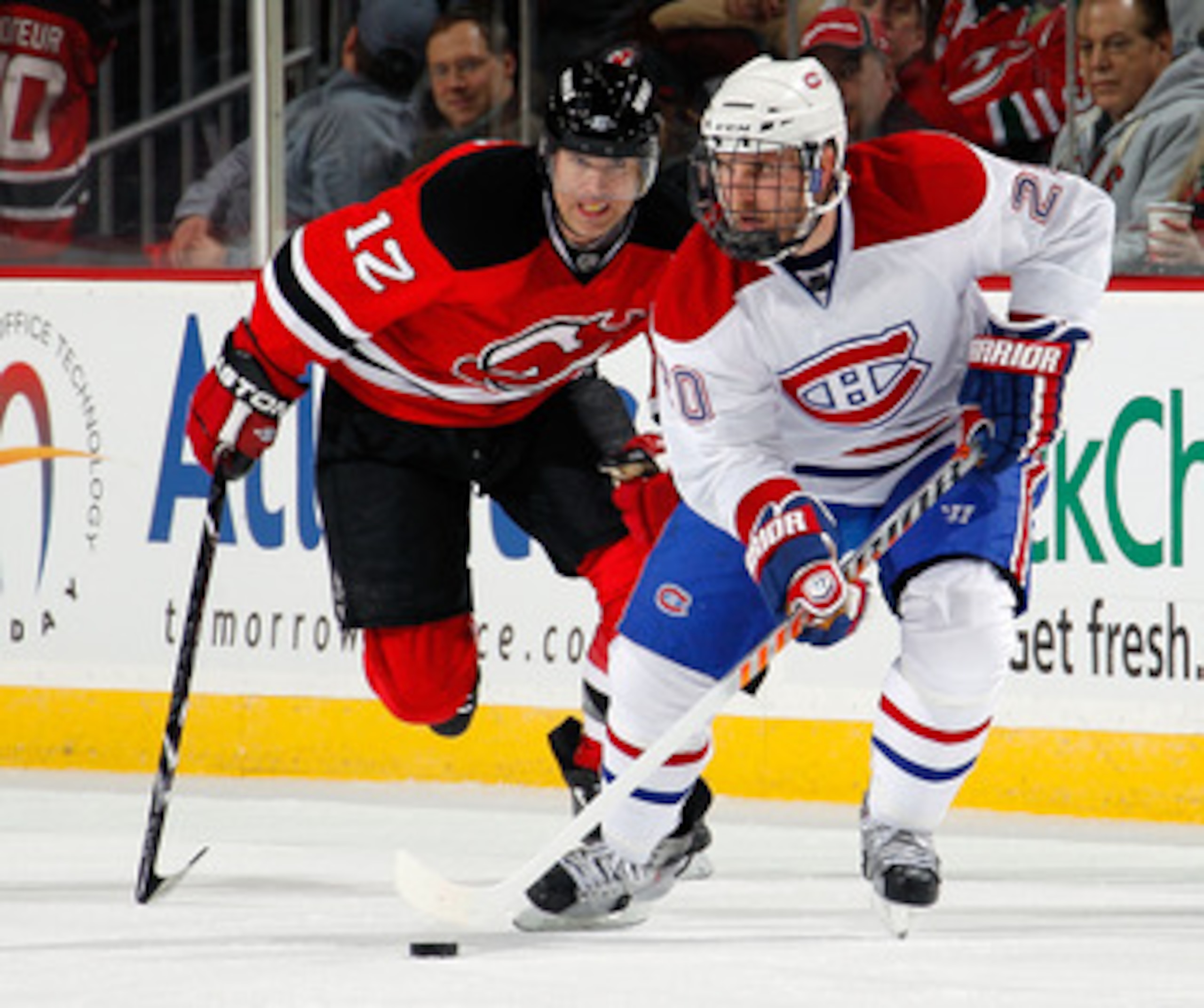 NEWARK, NJ - APRIL 02:  James Wisniewski #20 of the Montreal Canadians skates in front of Brian Rolston #12 of the New Jersey Devils during the first period of an NHL hockey game at the Prudential Center on April 2, 2011 in Newark, New Jersey.  (Photo by