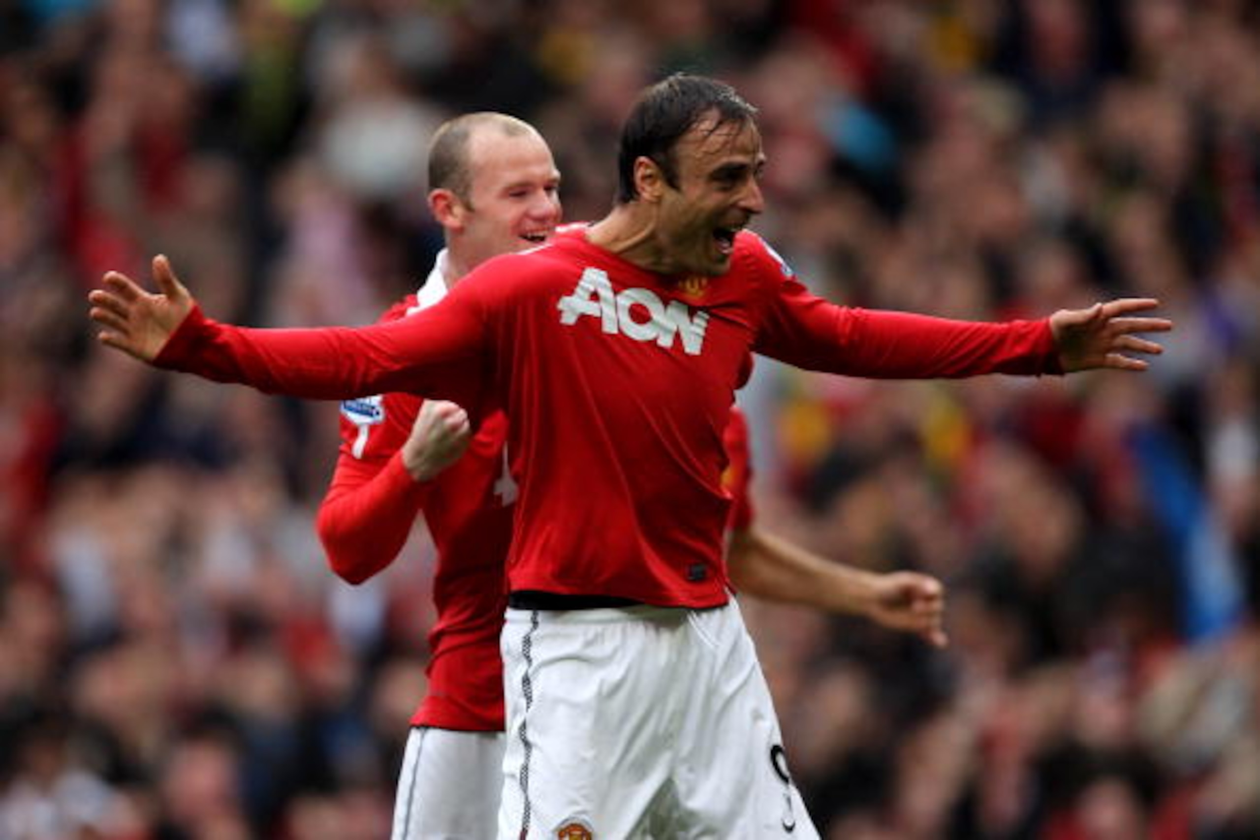 MANCHESTER, ENGLAND - SEPTEMBER 19:  Dimitar Berbatov of Manchester United celebrates scoring his team's second goal with team mate Wayne Rooney during the Barclays Premier League match between Manchester United and Liverpool at Old Trafford on September 