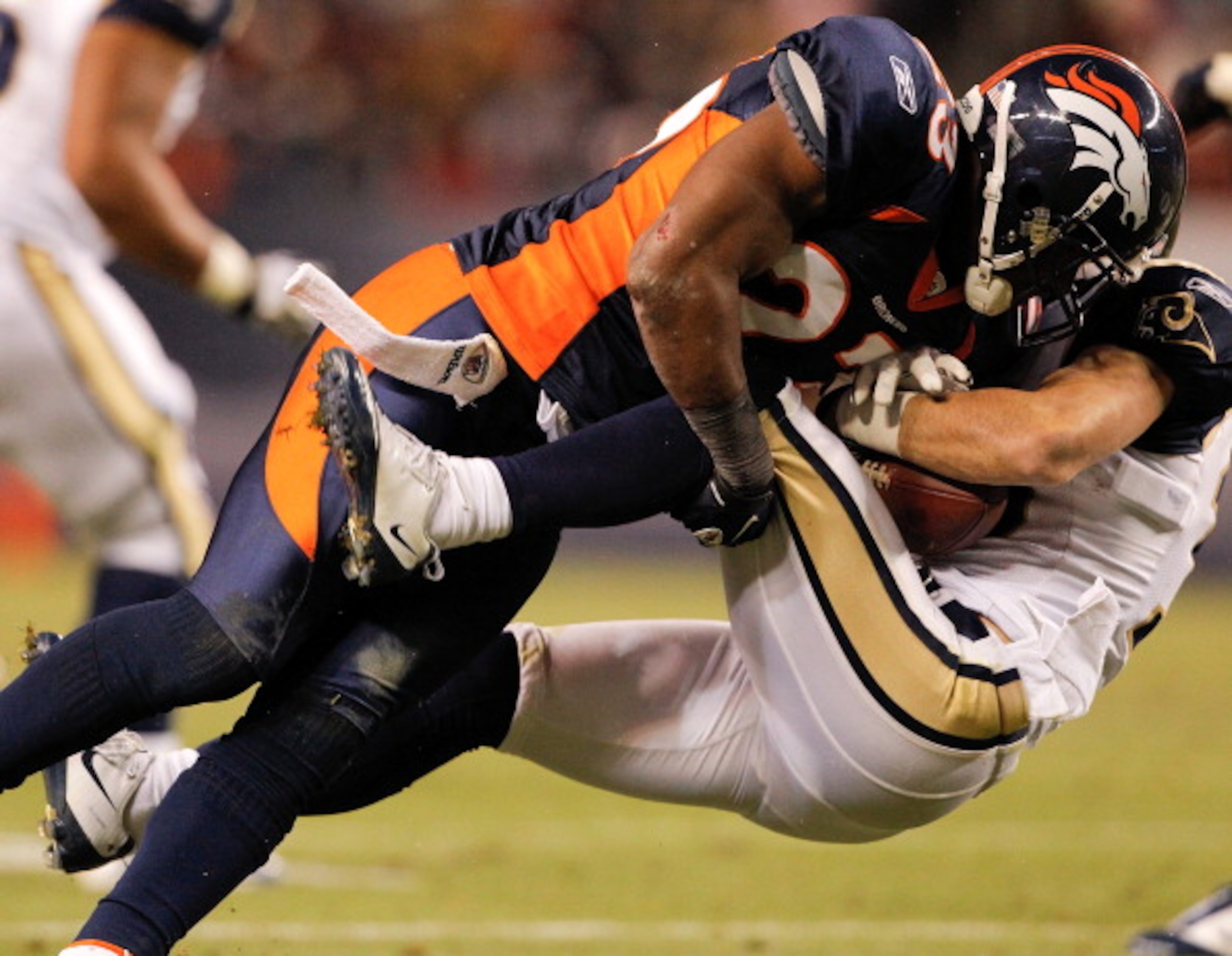 DENVER - NOVEMBER 28:  Safety Renaldo Hill #23 of the Denver Broncos tackles wide receiver Danny Amendola #16 of the St. Louis Rams during the fourth quarter at INVESCO Field at Mile High on November 28, 2010 in Denver, Colorado. The Rams defeated the Bro