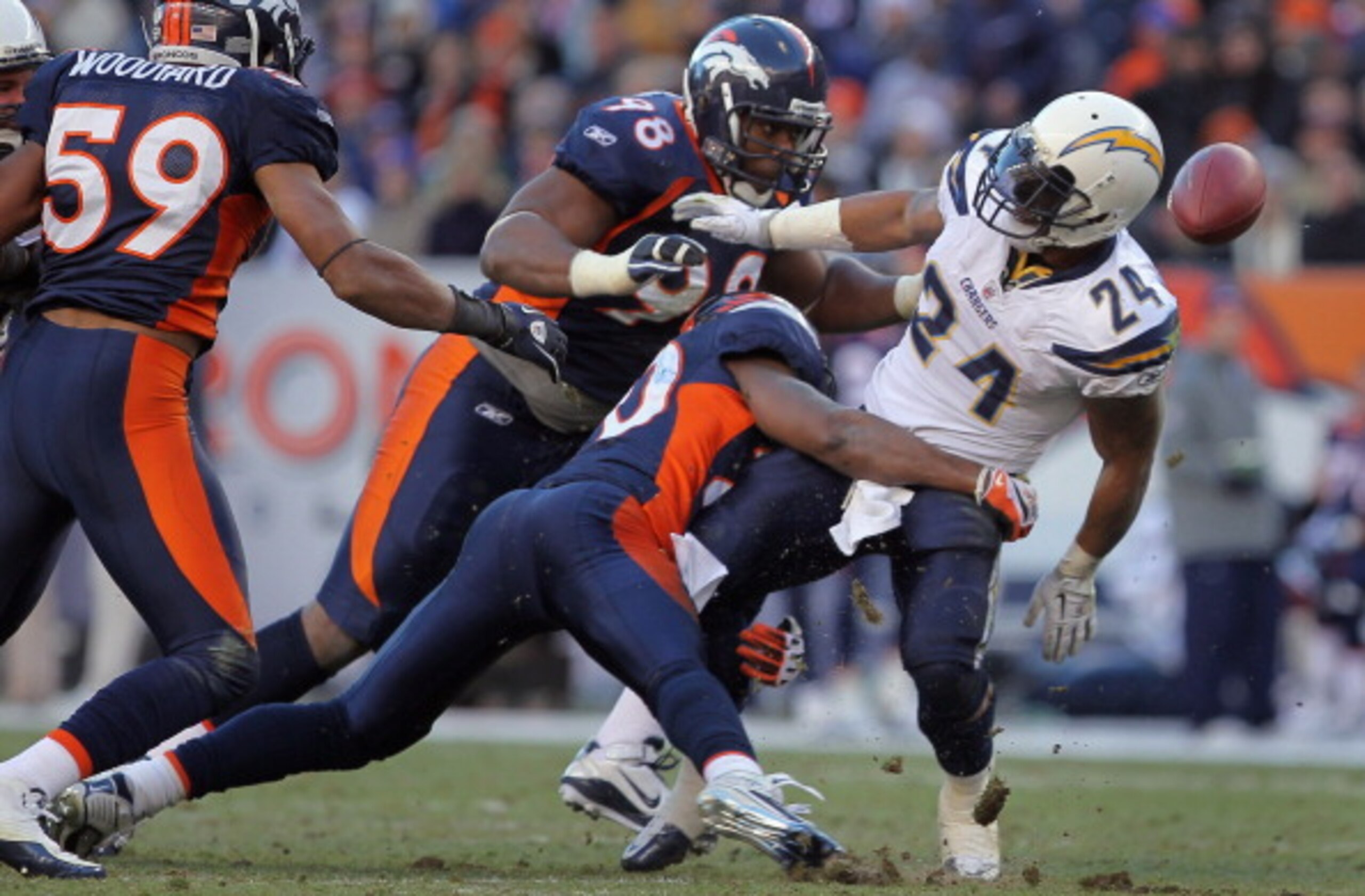 DENVER - JANUARY 02:  Running back Ryan Mathews #24 of the San Diego Chargers fumbles the ball as he is tackled by Brian Dawkins #20 of the Denver Broncos at INVESCO Field at Mile High on January 2, 2011 in Denver, Colorado. The ball was recovered by Kris