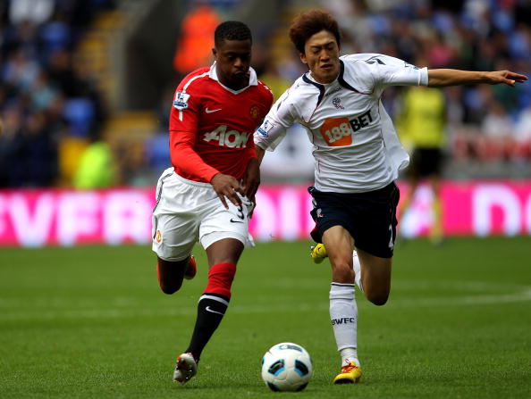 BOLTON, ENGLAND - SEPTEMBER 26:  Chung Yong Lee of Bolton Wanderers competes with Patrice Evra of Manchester United during the Barclays Premier League match between Bolton Wanderers and Manchester United at the Reebok Stadium on September 26, 2010 in Bolt