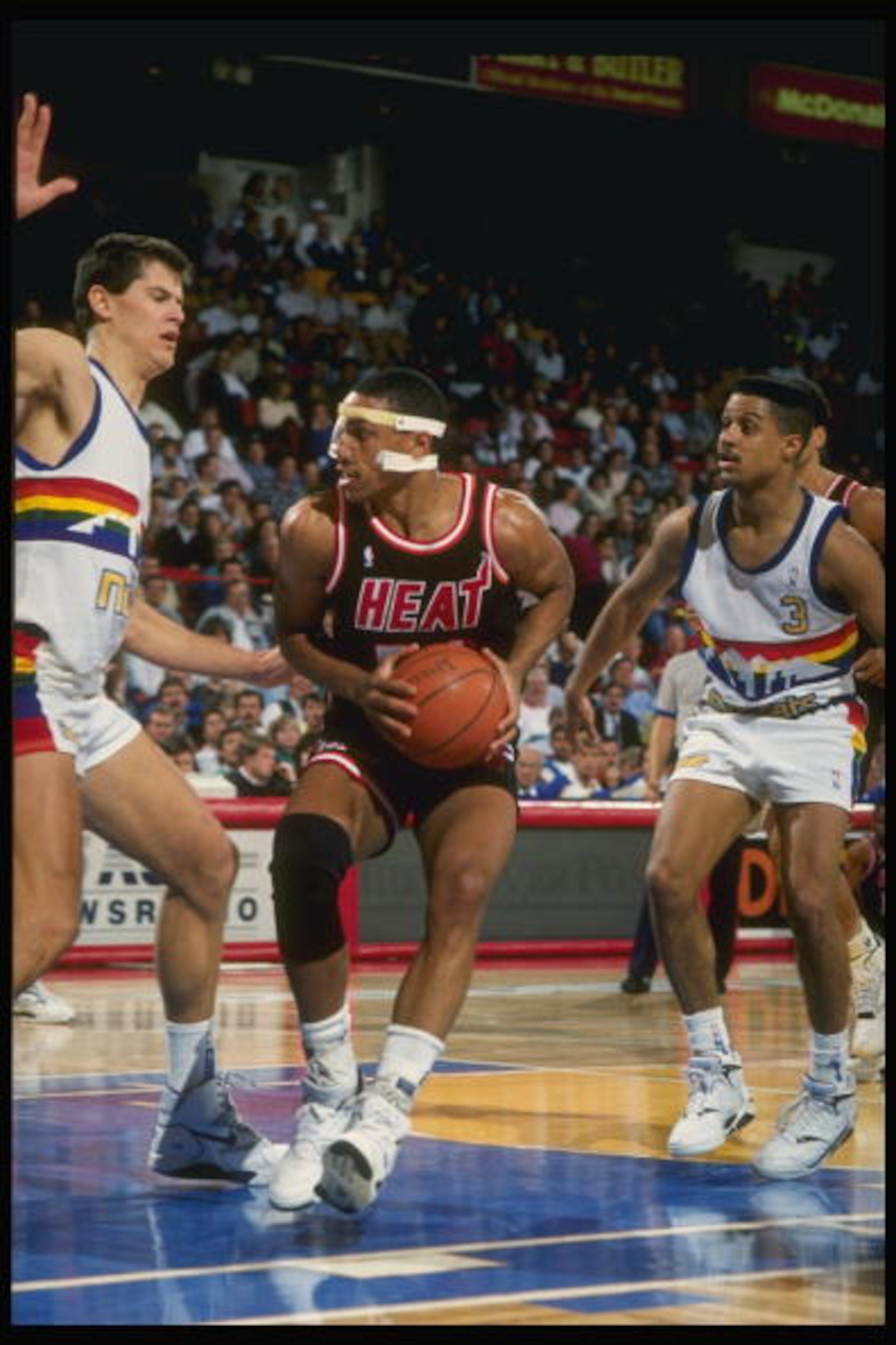 1989:  Guard Kevin Edwards of the Miami Heat (center) drives the ball past center Blair Rasmussen (left) and guard Chris Jackson of the Denver Nuggets during a game at the McNichols Arena in Denver, Colorado. Mandatory Credit: Tim de Frisco  /Allsport