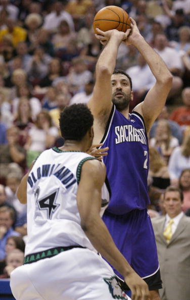 MINNEAPOLIS - MAY 8: Vlade Divac #21 of the Sacramento Kings takes a shot over Michael Olowokandi #34 of the Minnesota Timberwolves in game 2 of the NBA Western Conference Semifinals May 8, 2004 at the Target Center  in Minneapolis, Minnesota.  NOTE TO US