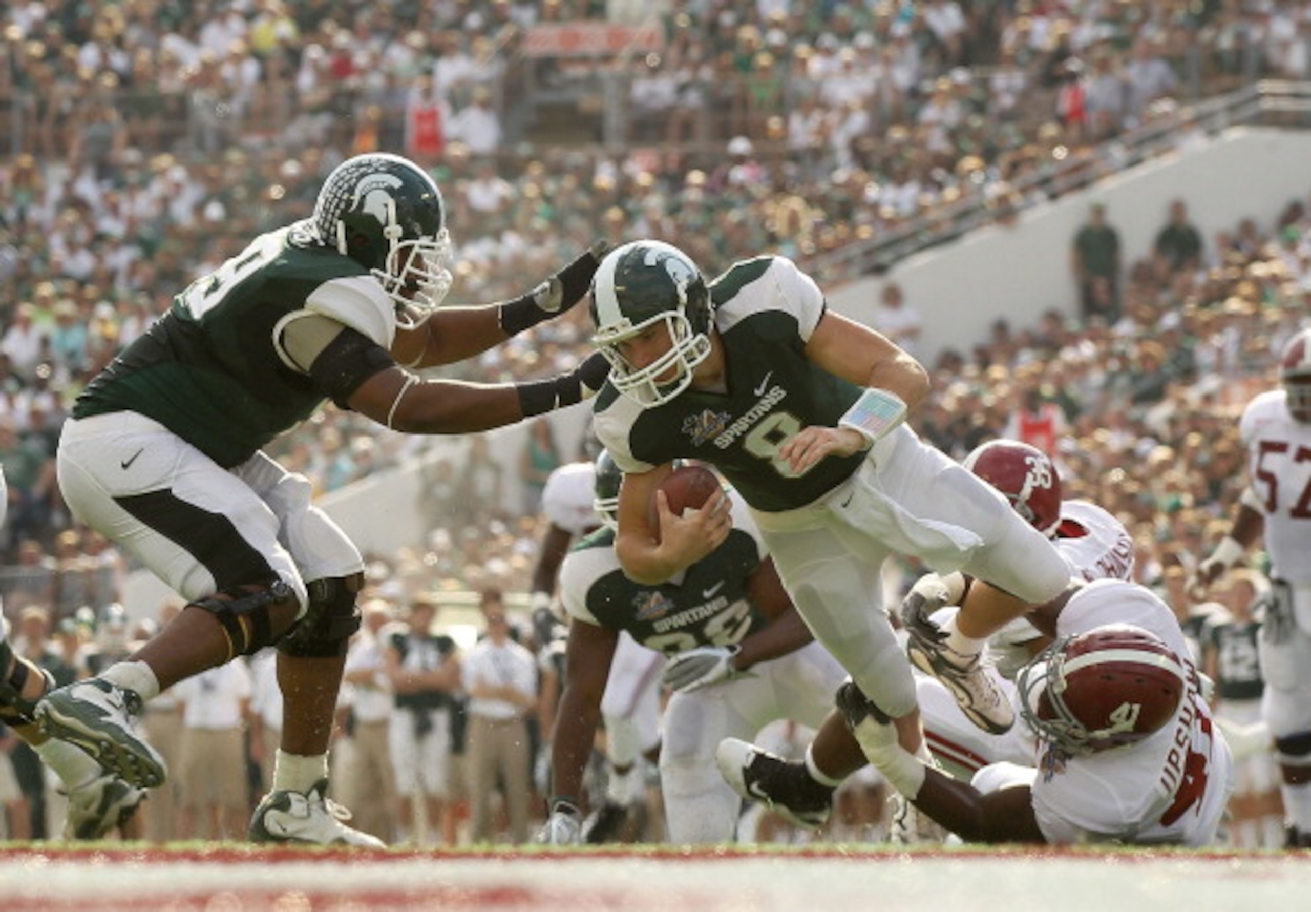 ORLANDO, FL - JANUARY 01:  Kirk Cousins #8  of the Michigan State Spartans is sacked by Courtney Upshaw #41 of the Alabama Crimson Tide during the Capitol One Bowl at the Florida Citrus Bowl on January 1, 2011 in Orlando, Florida.  (Photo by Mike Ehrmann/