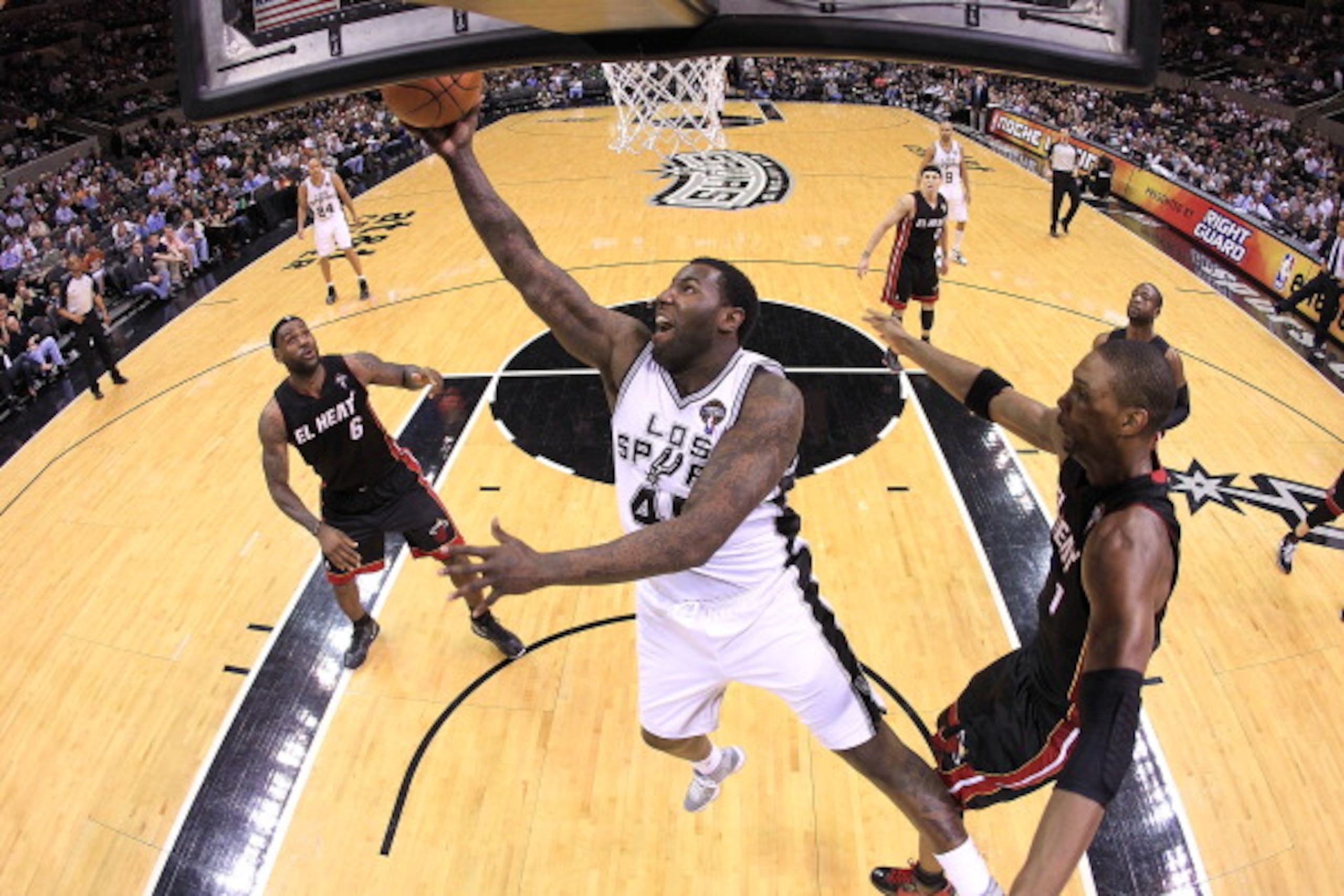 SAN ANTONIO, TX - MARCH 04:  Forward DeJuan Blair #45 of the San Antonio Spurs takes a shot against Chris Bosh #1 of the Miami Heat at AT&T Center on March 4, 2011 in San Antonio, Texas.   NOTE TO USER: User expressly acknowledges and agrees that, by down