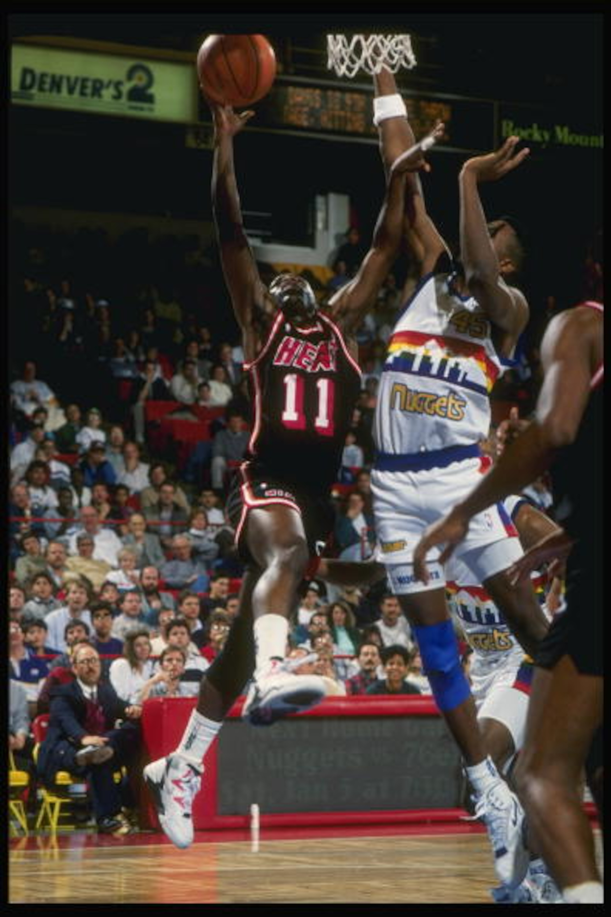 1989:  Guard Sherman Douglas of the Miami Heat (left) goes up for two as forward Anthony Cook of the Denver Nuggets tries to block the shot during a game at the McNichols Arena in Denver, Colorado. Mandatory Credit: Tim de Frisco  /Allsport