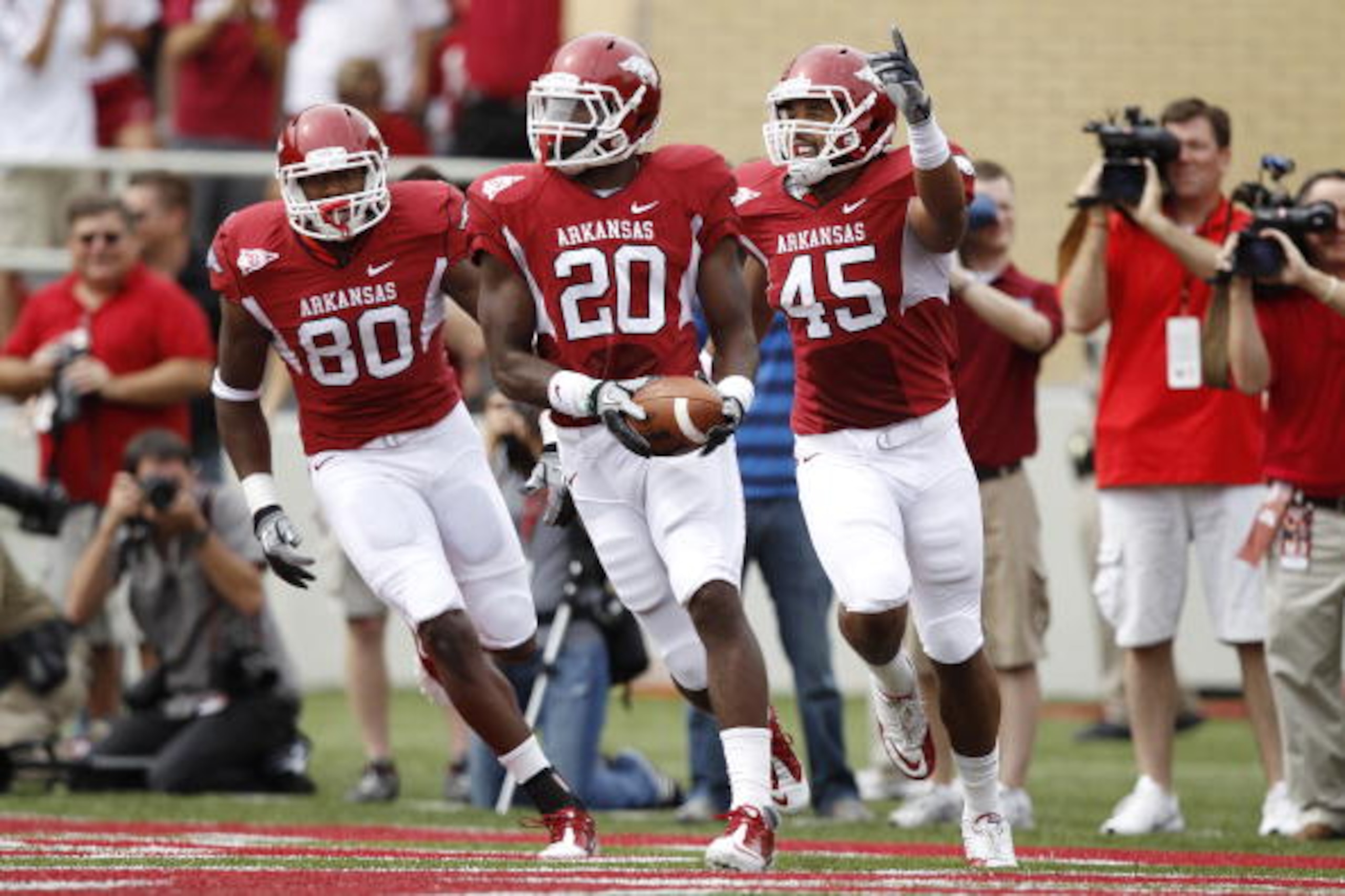 FAYETTEVILLE - SEPTEMBER 25: Ronnie Wingo Jr. #20 of the Arkansas Razorbacks celebrates with teammates D.J. Williams #45 and Chris Gragg #80 after a first half touchdown against the Alabama Crimson Tide at Donald W. Reynolds Razorback Stadium on September