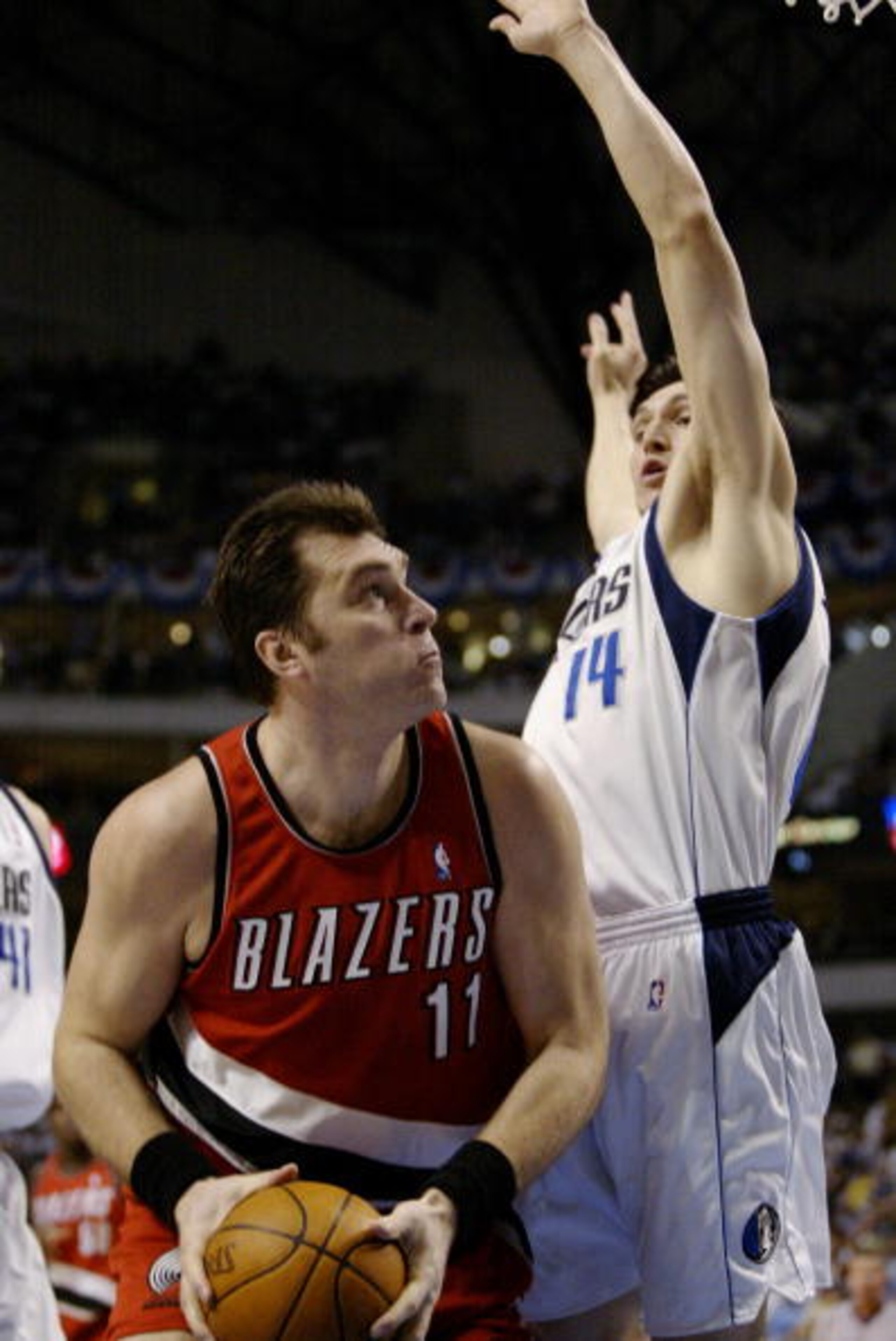 DALLAS - MAY 4:  Arvydas Sabonis #11 of the Portland Trail Blazers attempts to go to the basket while being guarded by Eduardo Najera #14 of the Dallas Mavericks in Game seven of the Western Conference Quarterfinals during the 2003 NBA Playoffs at America