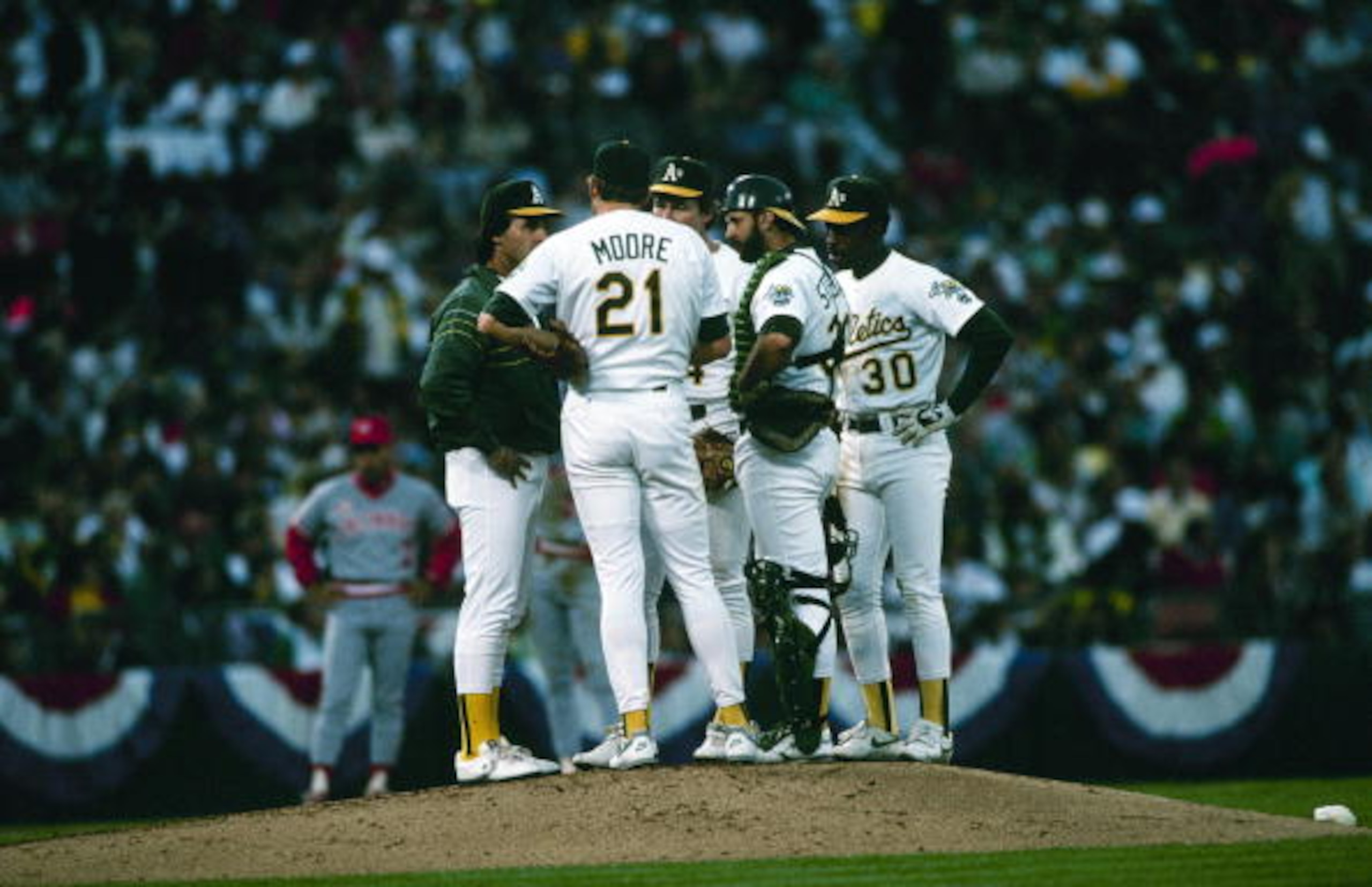 OAKLAND, CA - OCTOBER 19: (L-R) Manager Tony LaRussa, pitcher Mike Moore #21, Carney Lansford #4, catcher Terry Steinbach #36 and Willie Randolph #30 of the Oakland Athletics confer on the mound during Game Three of the 1990 World Series against the Cinci