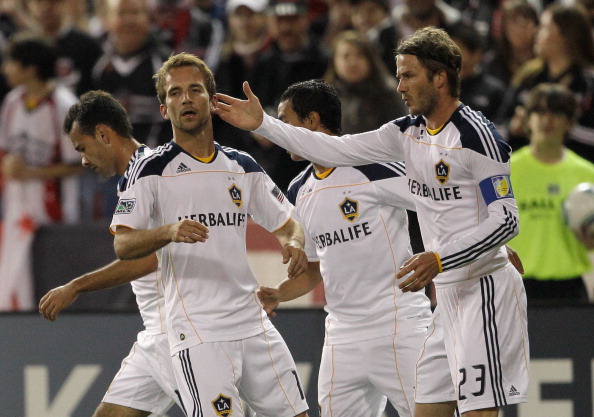 WASHINGTON, DC - APRIL 09:  Mike Magee #18 of the Los Angeles Galaxy (L) is congratulated by teammate David Beckham #23 after Magee scored a goal against the D.C. United during the first half at RFK Stadium on April 9, 2011 in Washington, DC.  (Photo by R