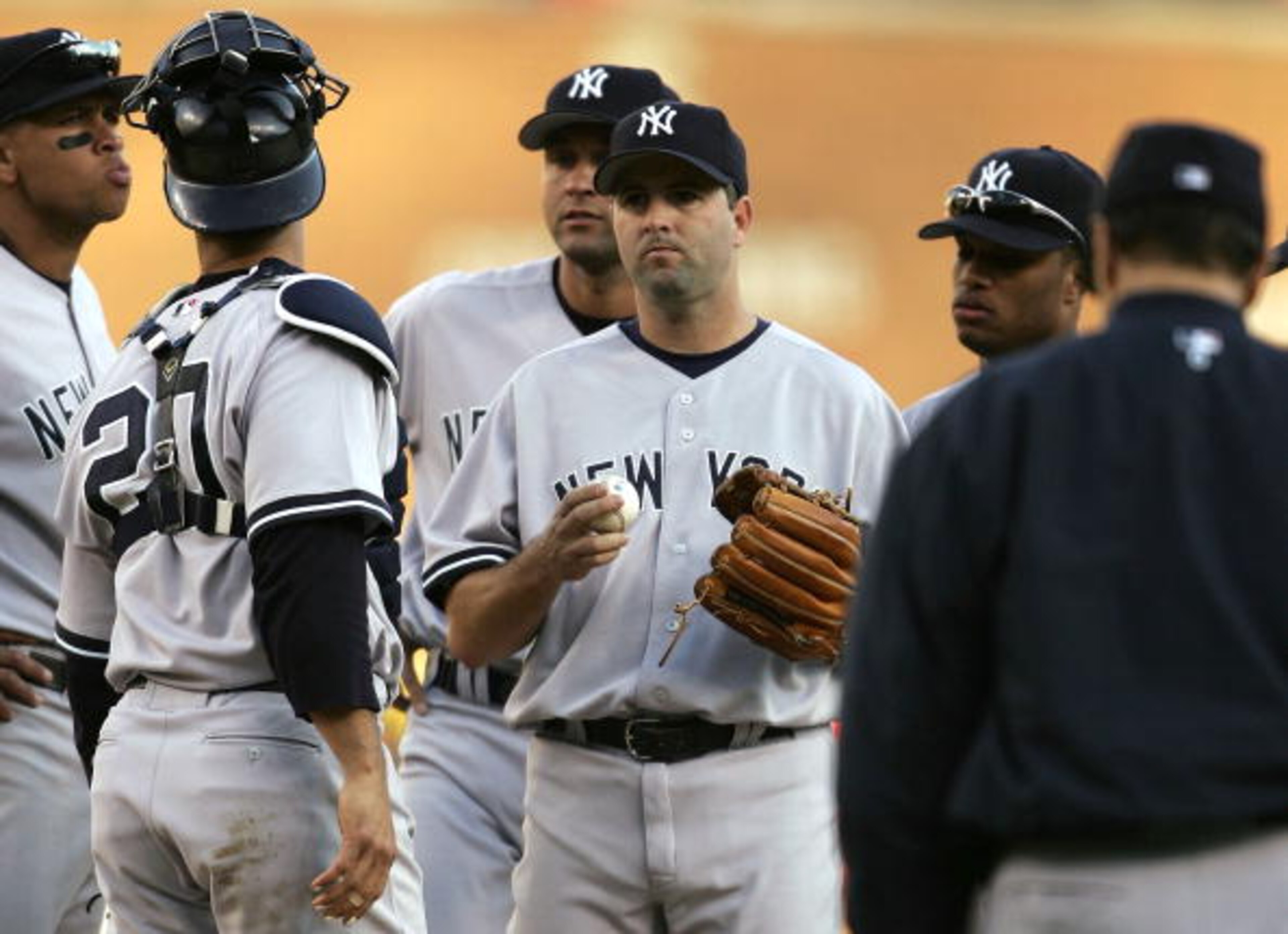 DETROIT - OCTOBER 07:  Relief pitcher Cory Lidle #30 (C - holding ball) of the New York Yankees is surrounded by teammates (L-R) Alex Rodriguez #13, Jorge Posada #20, Derek Jeter #2 and Robinson Cano #22 as manager Joe Torre walks to the mound to relieve 
