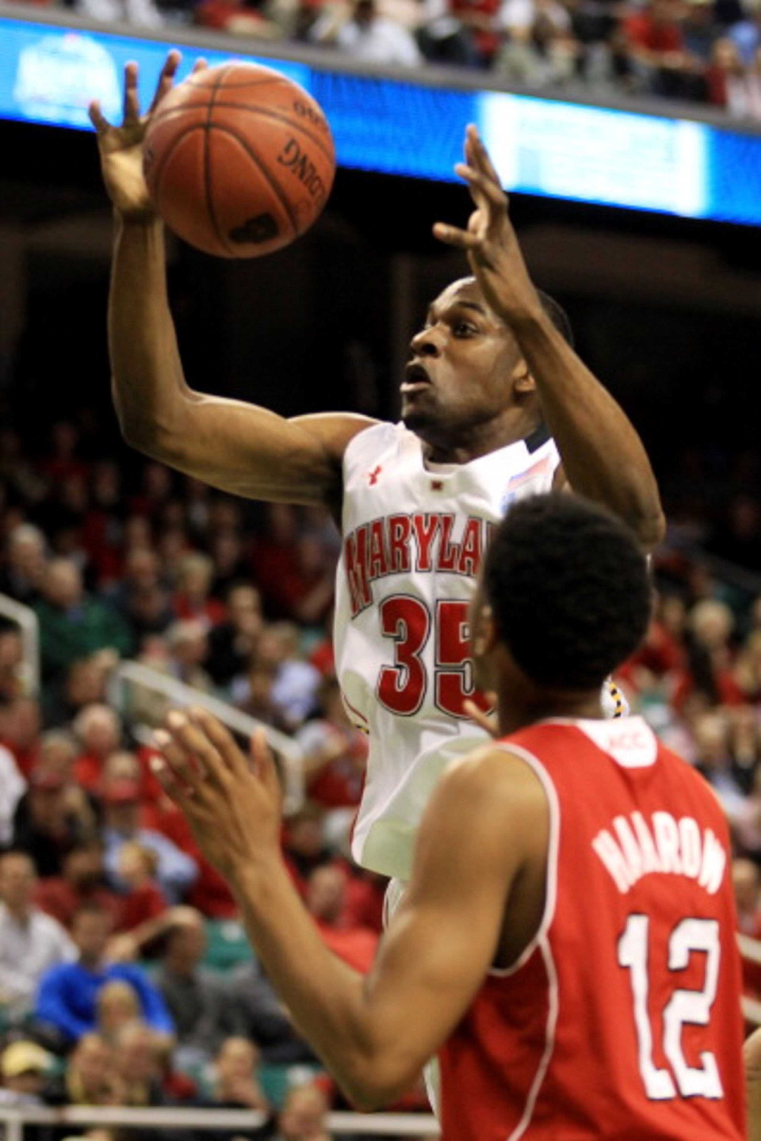 GREENSBORO, NC - MARCH 10:  James Padgett #35 of the Maryland Terrapins loses possession of the ball against Ryan Harrow #12 of the North Carolina State Wolfpack during the first round of the 2011 ACC men's basketball tournament at the Greensboro Coliseum