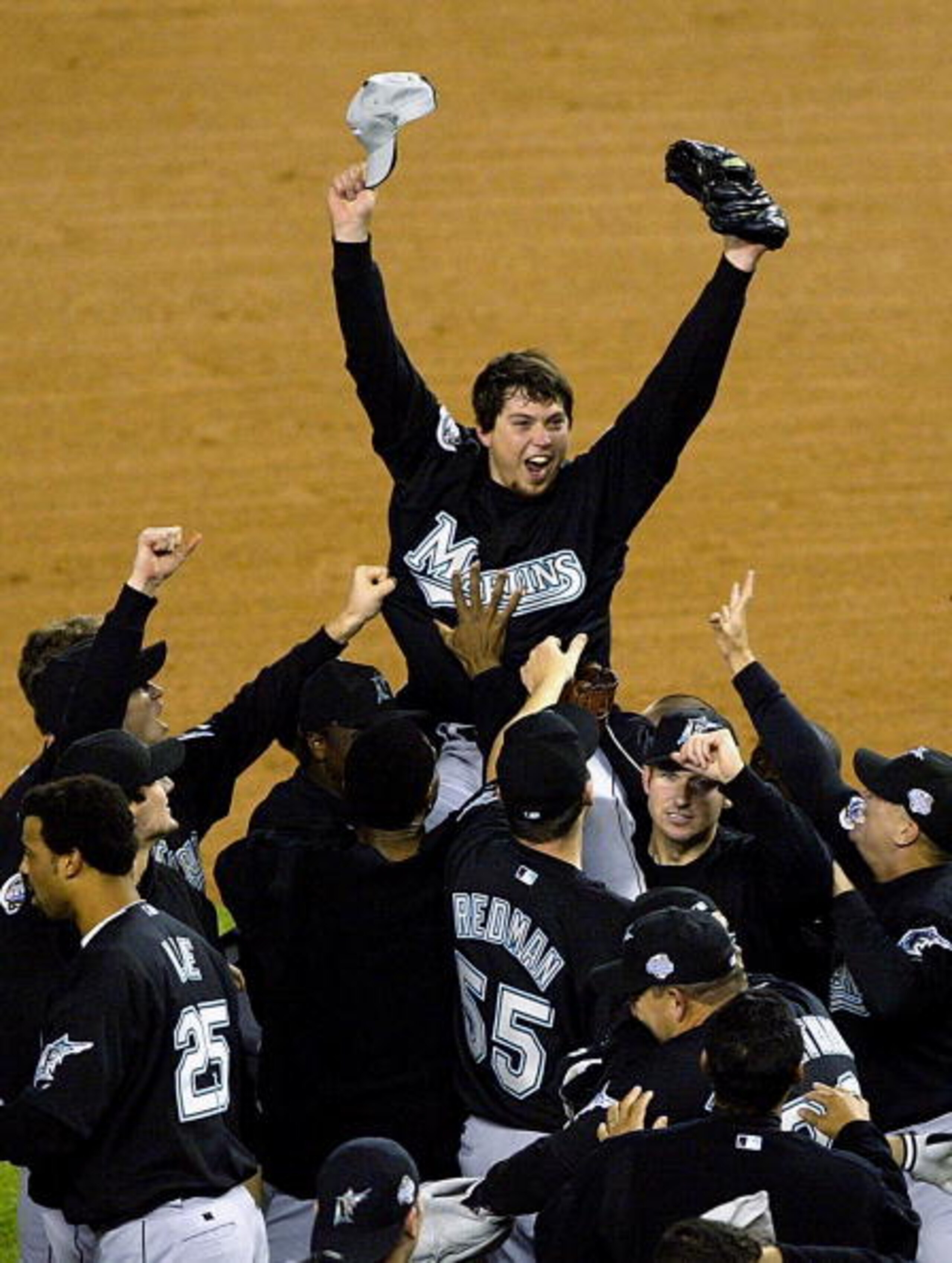 RONX, NY - OCTOBER 25:  The Florida Marlins hoist up pitcher Josh Beckett #21 the 2003 World Series MVP after defeating the New York Yankees 2-0 in game six of the Major League Baseball World Series on October 25, 2003 at Yankee Stadium in the Bronx, New 