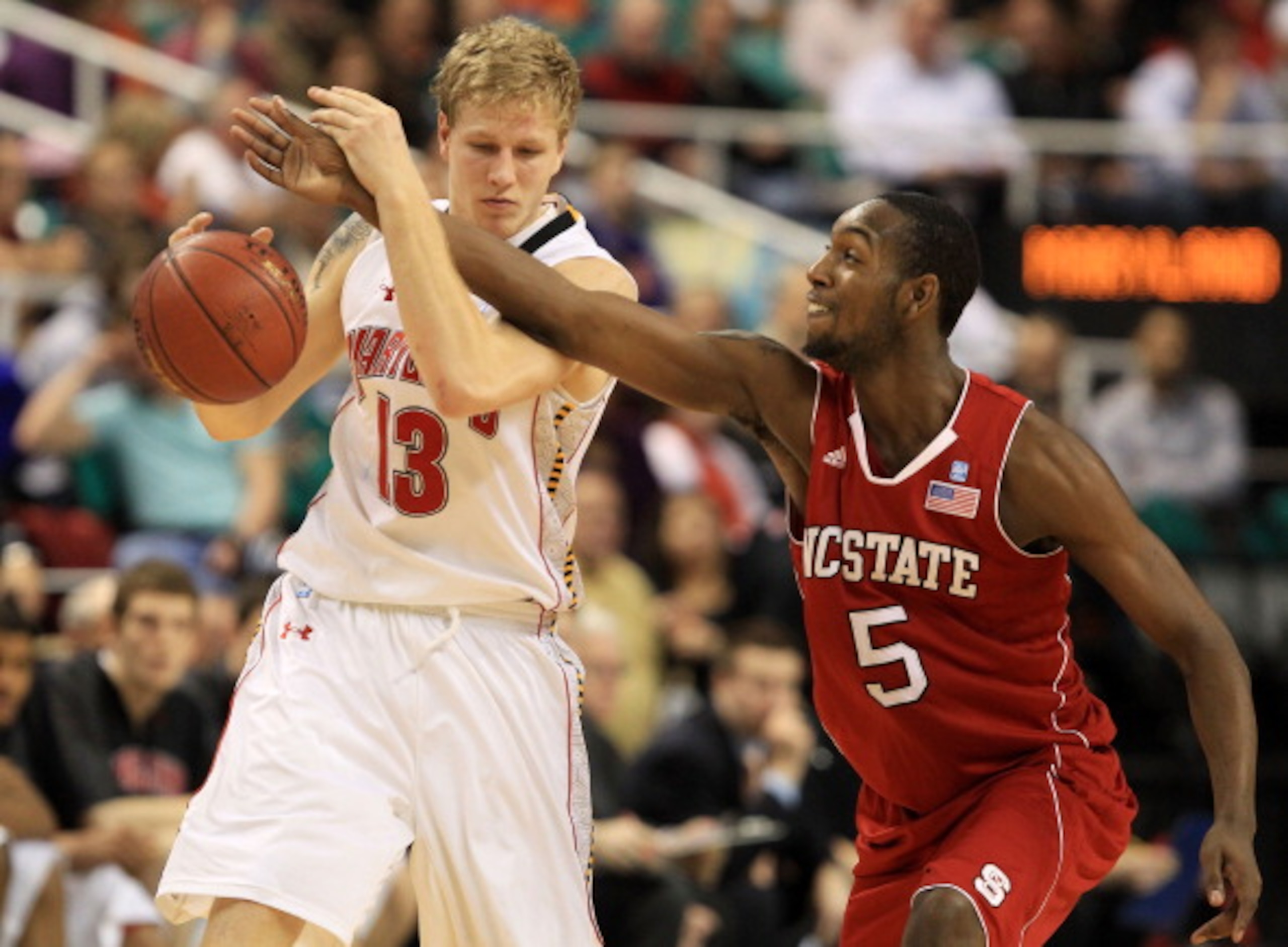 GREENSBORO, NC - MARCH 10:  Haukur Palsson #13 of the Maryland Terrapins controls the ball against C.J. Leslie #5 of the North Carolina State Wolfpack during the second half of the game in the first round of the 2011 ACC men's basketball tournament at the