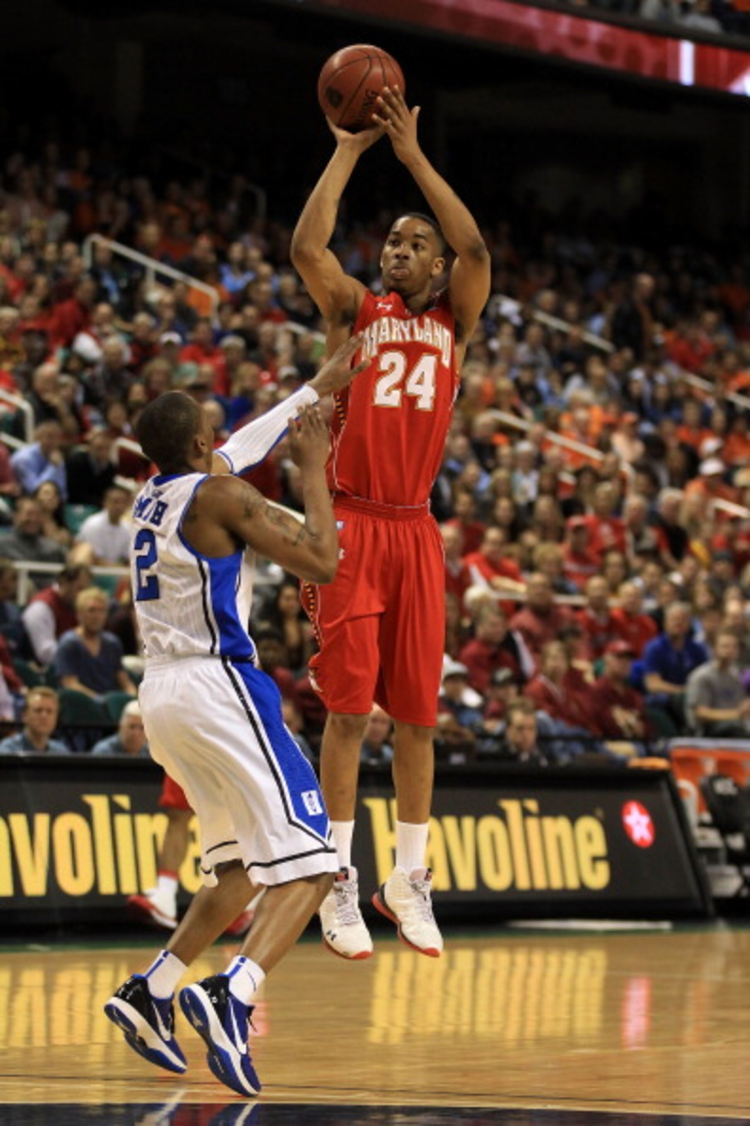 GREENSBORO, NC - MARCH 11:  Cliff Tucker #24 of the Maryland Terrapins shoots against Nolan Smith #2 of the Duke Blue Devils during the first half in the quarterfinals of the 2011 ACC men's basketball tournament at the Greensboro Coliseum on March 11, 201
